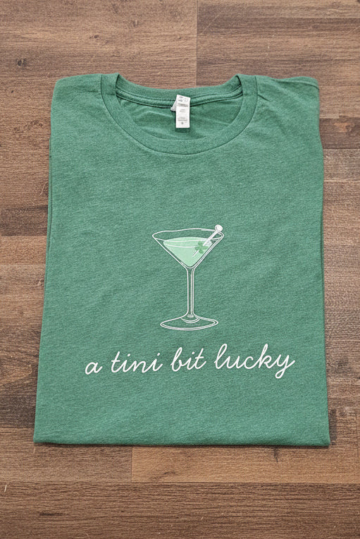 Shop A Tini Bit Lucky | St. Patrick's Day Graphic Top- at Ruby Joy Boutique, a Women's Clothing Store in Pickerington, Ohio
