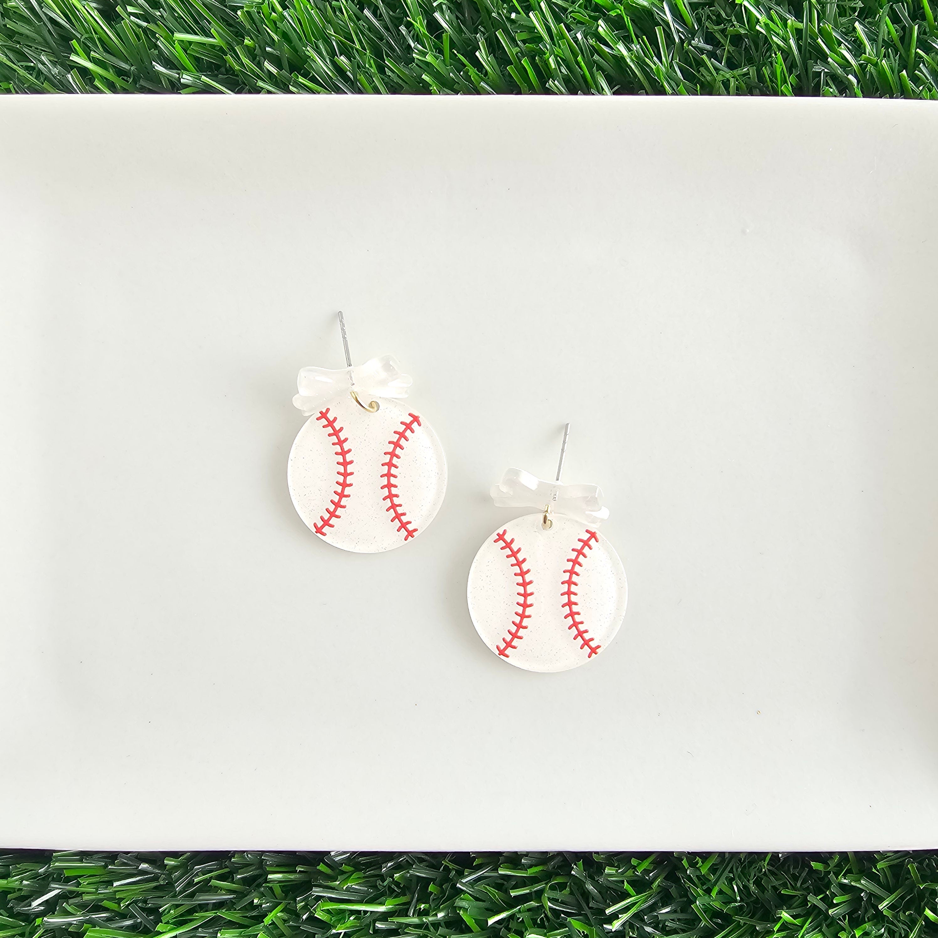 Shop Bow Baseball Earrings- at Ruby Joy Boutique, a Women's Clothing Store in Pickerington, Ohio