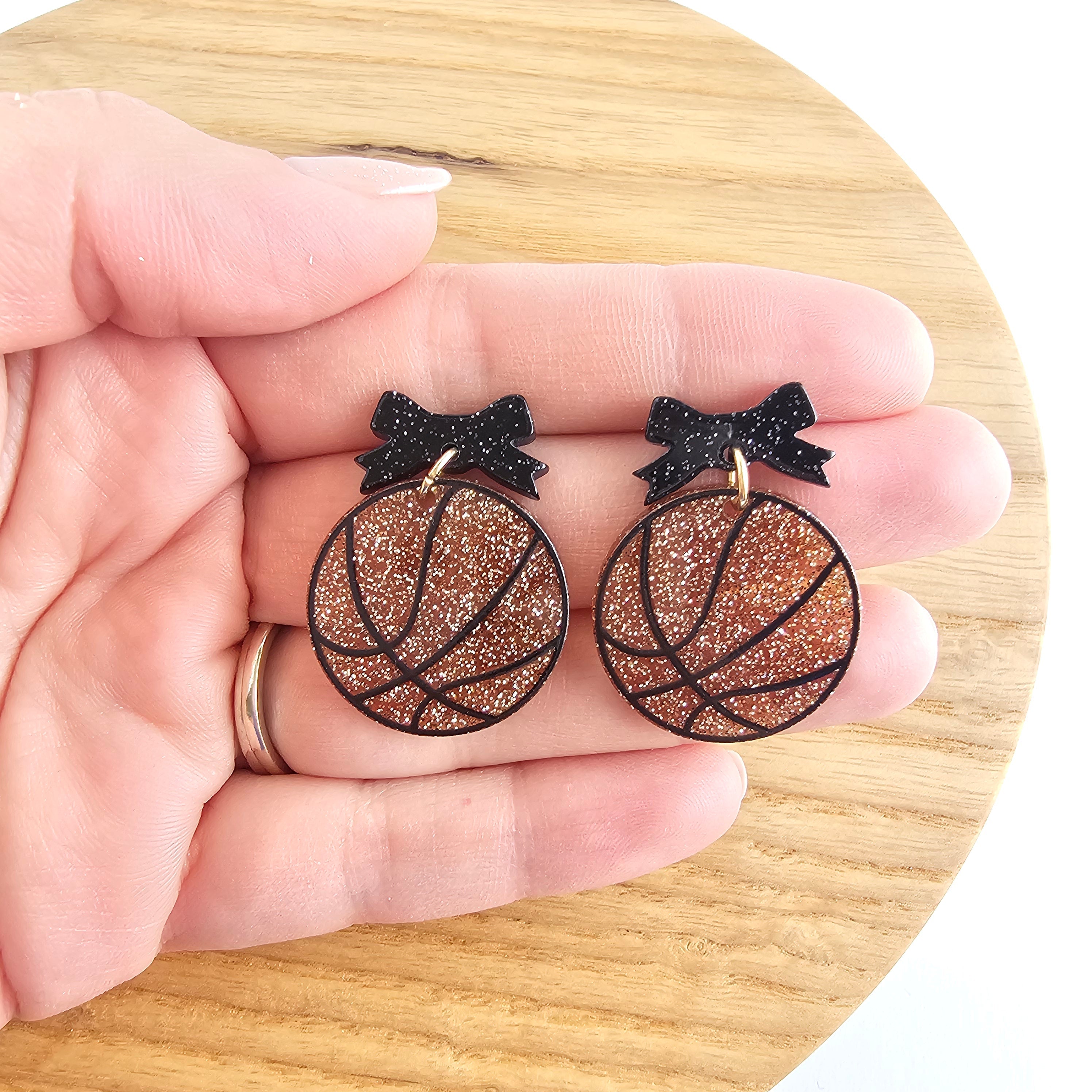 Shop Bow Basketball Earrings- at Ruby Joy Boutique, a Women's Clothing Store in Pickerington, Ohio
