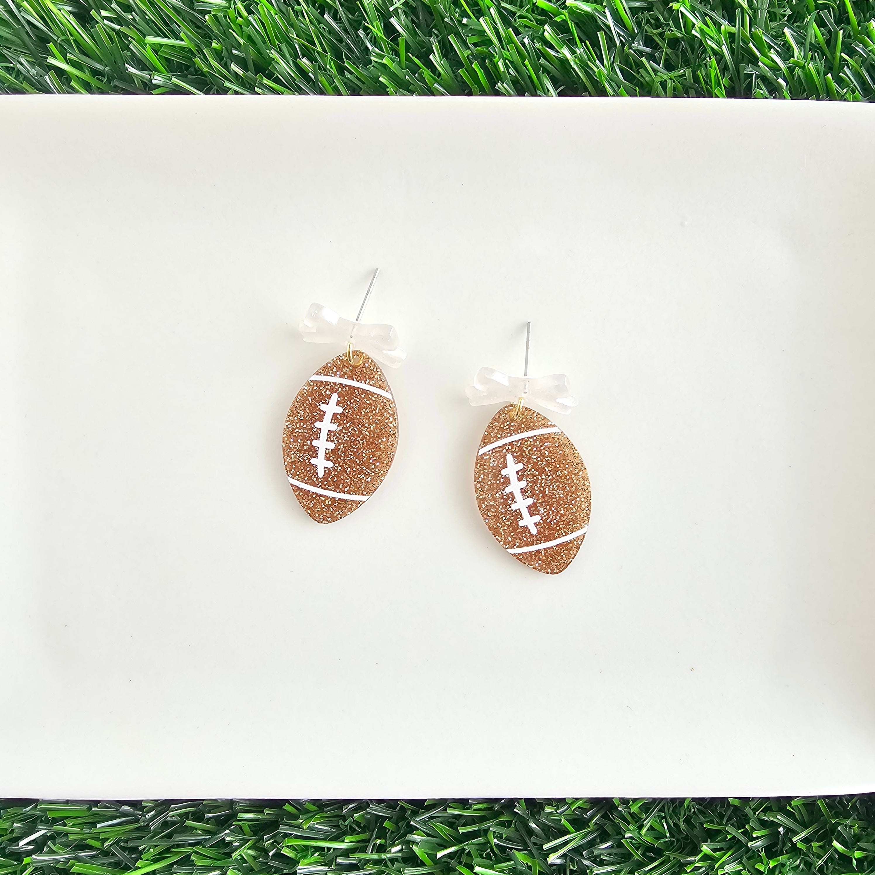 Shop Bow Football Earrings- at Ruby Joy Boutique, a Women's Clothing Store in Pickerington, Ohio
