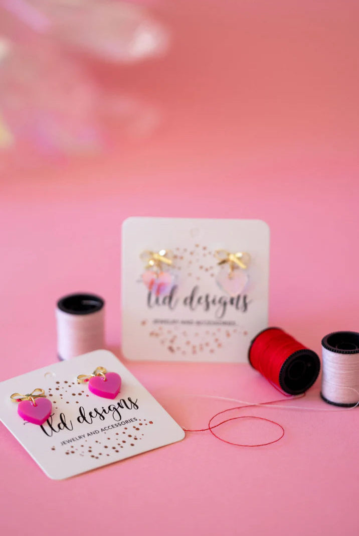 Shop Bow Heart Dangle Earrings- at Ruby Joy Boutique, a Women's Clothing Store in Pickerington, Ohio