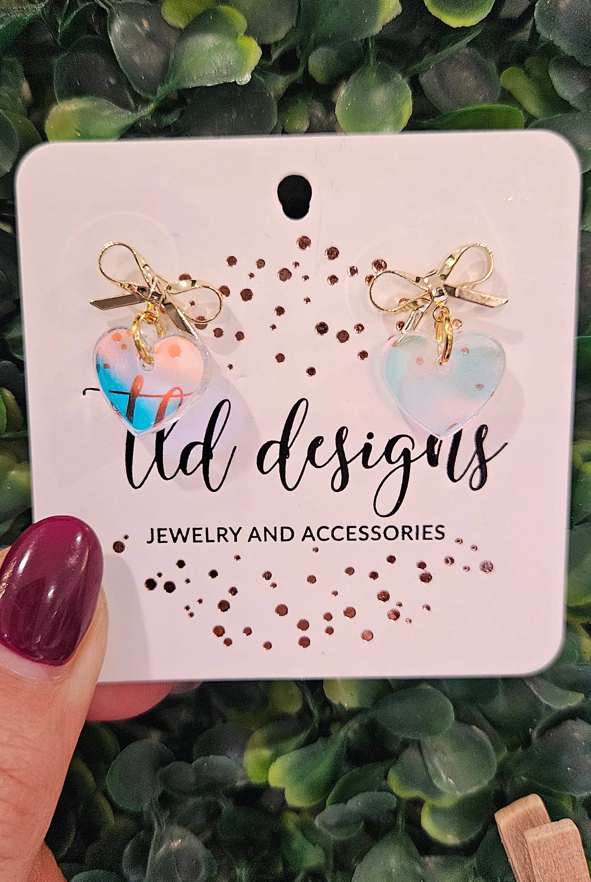 Shop Bow Heart Dangle Earrings-Clear Iridescent at Ruby Joy Boutique, a Women's Clothing Store in Pickerington, Ohio