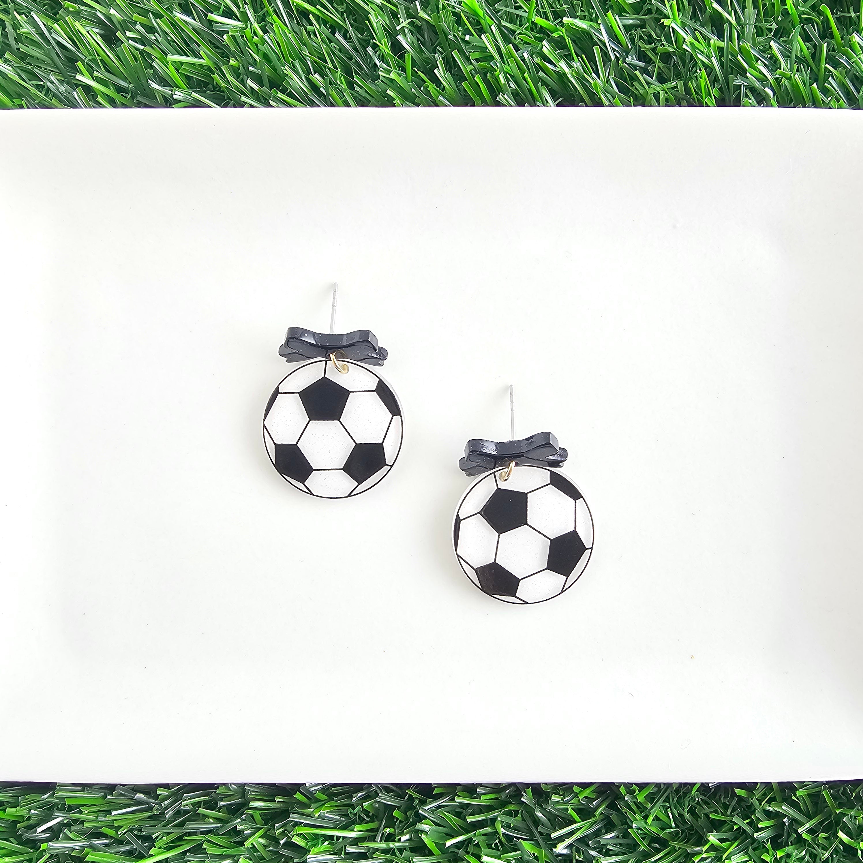 Shop Bow Soccer Ball Earrings- at Ruby Joy Boutique, a Women's Clothing Store in Pickerington, Ohio