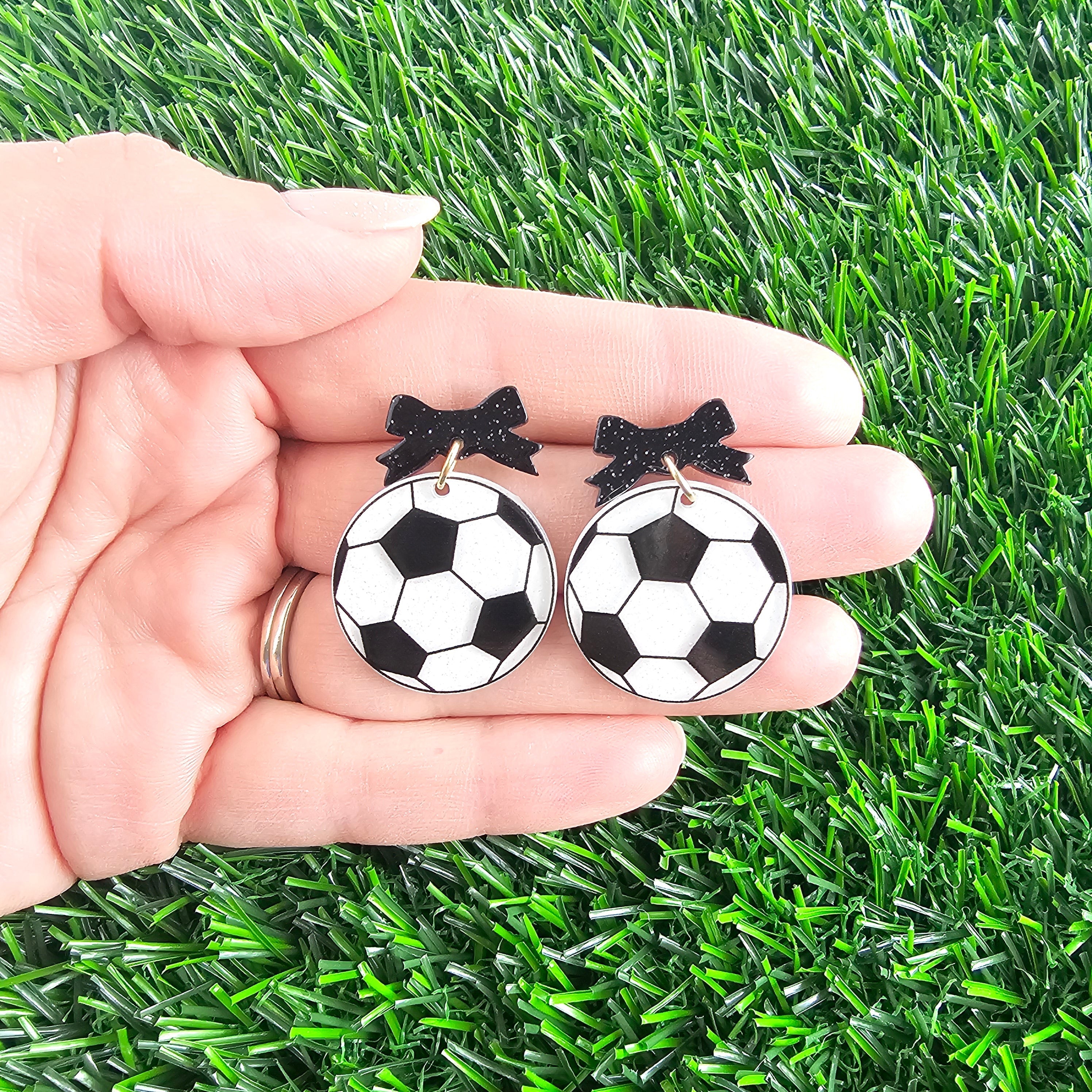 Shop Bow Soccer Ball Earrings- at Ruby Joy Boutique, a Women's Clothing Store in Pickerington, Ohio