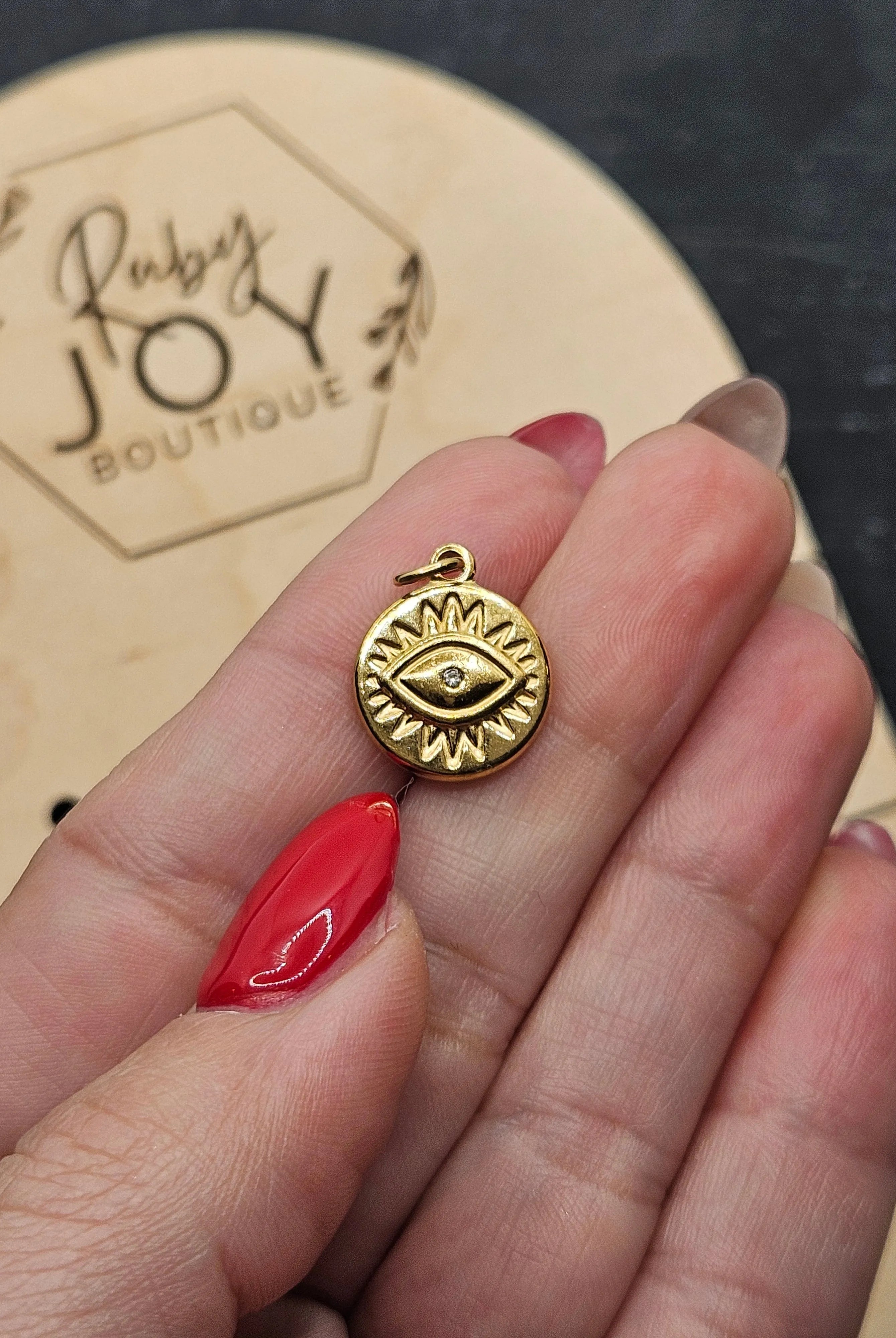 Shop Evil Eye Sun Disc Charm- at Ruby Joy Boutique, a Women's Clothing Store in Pickerington, Ohio