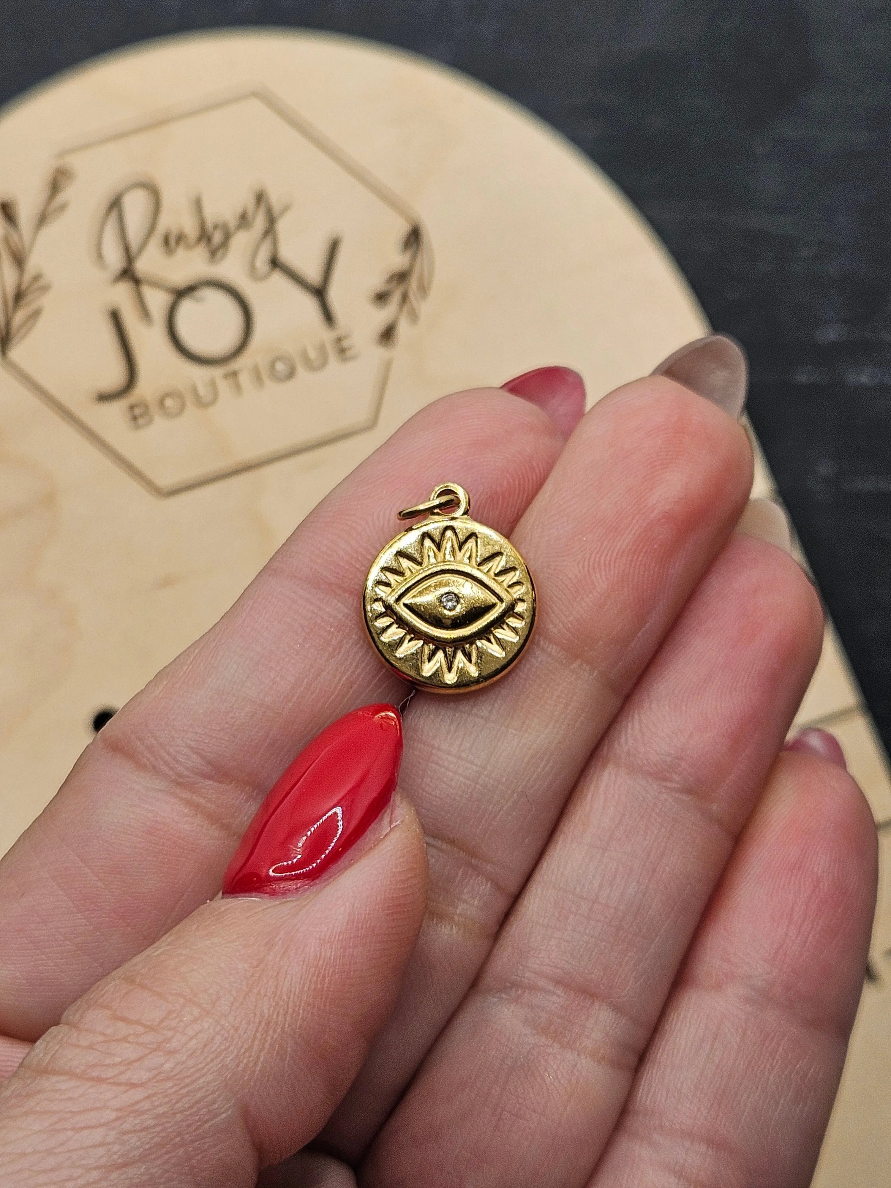 Shop Evil Eye Sun Disc Charm- at Ruby Joy Boutique, a Women's Clothing Store in Pickerington, Ohio