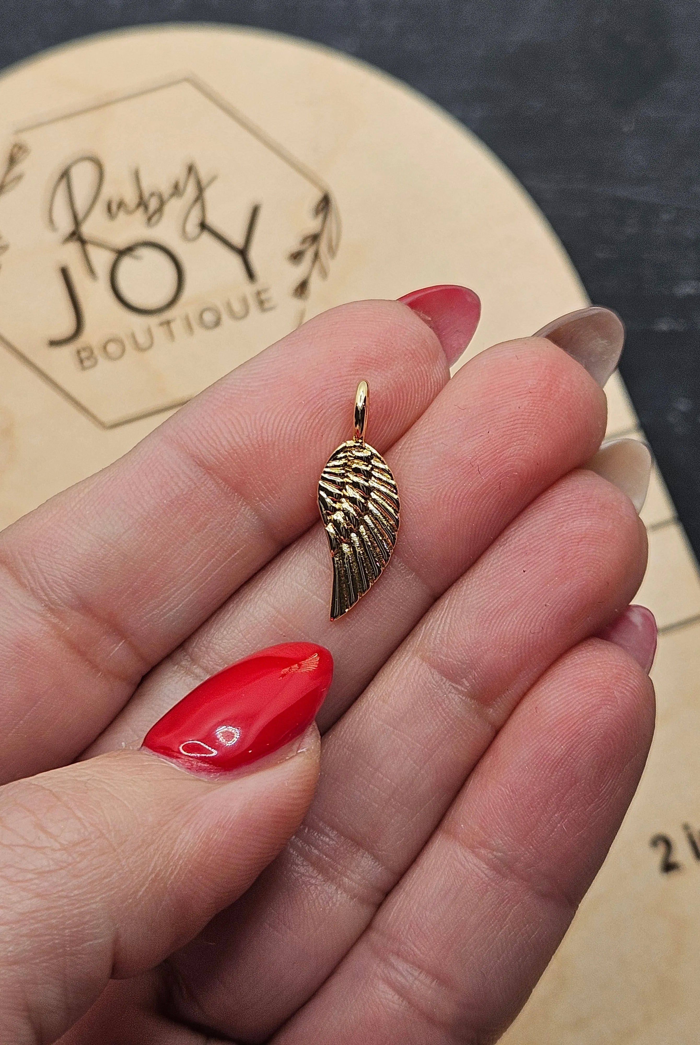 Shop Gold Wing Charm- at Ruby Joy Boutique, a Women's Clothing Store in Pickerington, Ohio