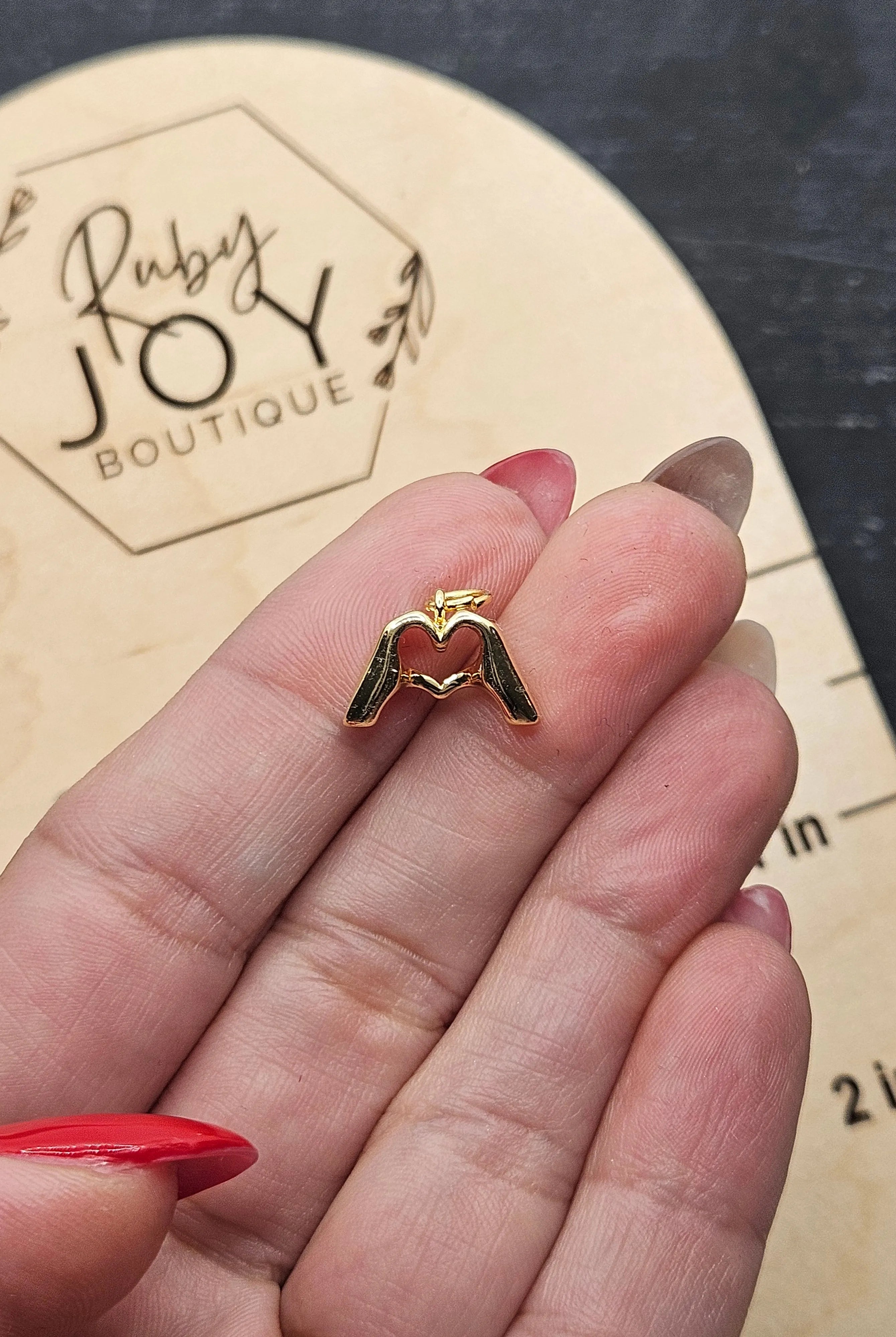 Shop Heart Hands Charm- at Ruby Joy Boutique, a Women's Clothing Store in Pickerington, Ohio
