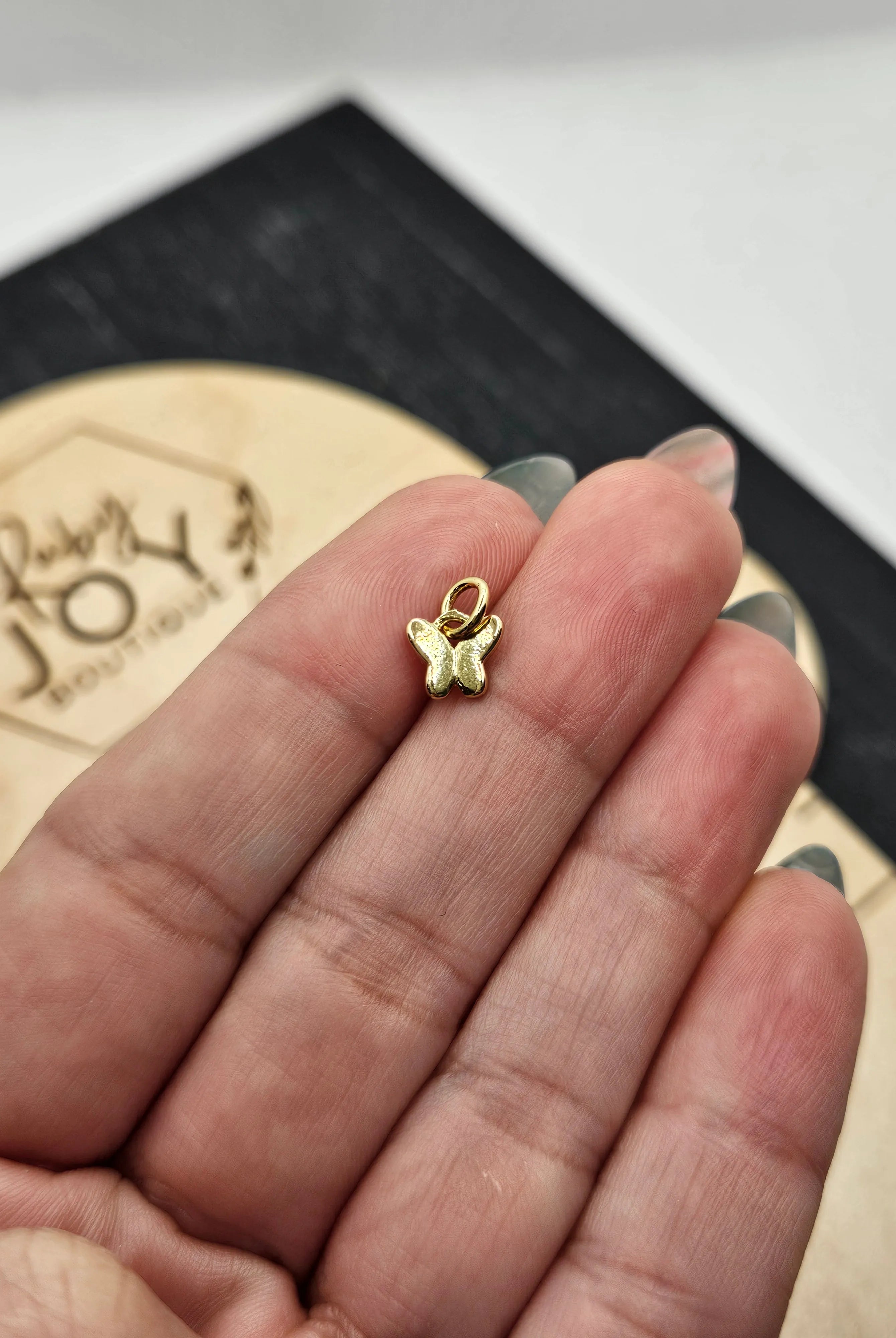Shop Mini Gold Butterfly Charm- at Ruby Joy Boutique, a Women's Clothing Store in Pickerington, Ohio