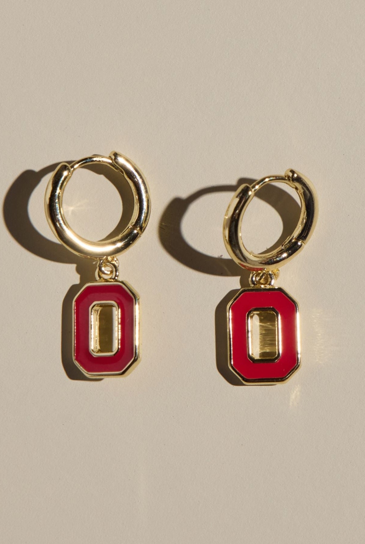 Shop Ohio State University Logo Charm Huggie Earrings- at Ruby Joy Boutique, a Women's Clothing Store in Pickerington, Ohio