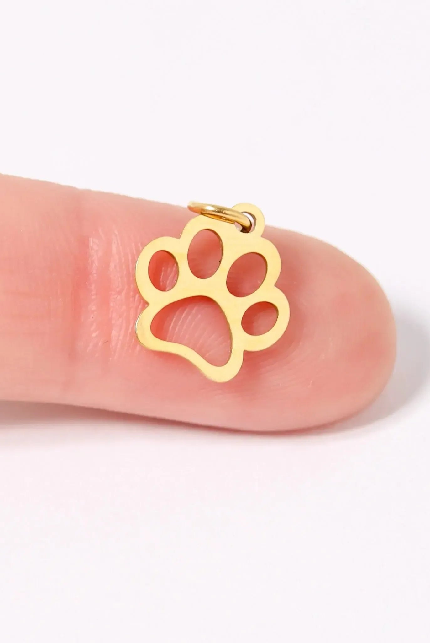 Shop Paw Print Outline Charm- at Ruby Joy Boutique, a Women's Clothing Store in Pickerington, Ohio