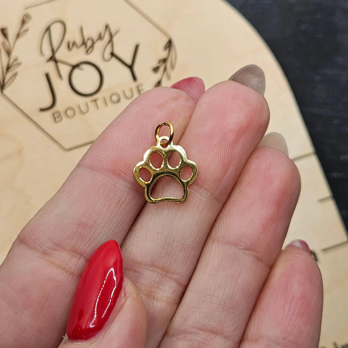 Shop Paw Print Outline Charm- at Ruby Joy Boutique, a Women's Clothing Store in Pickerington, Ohio