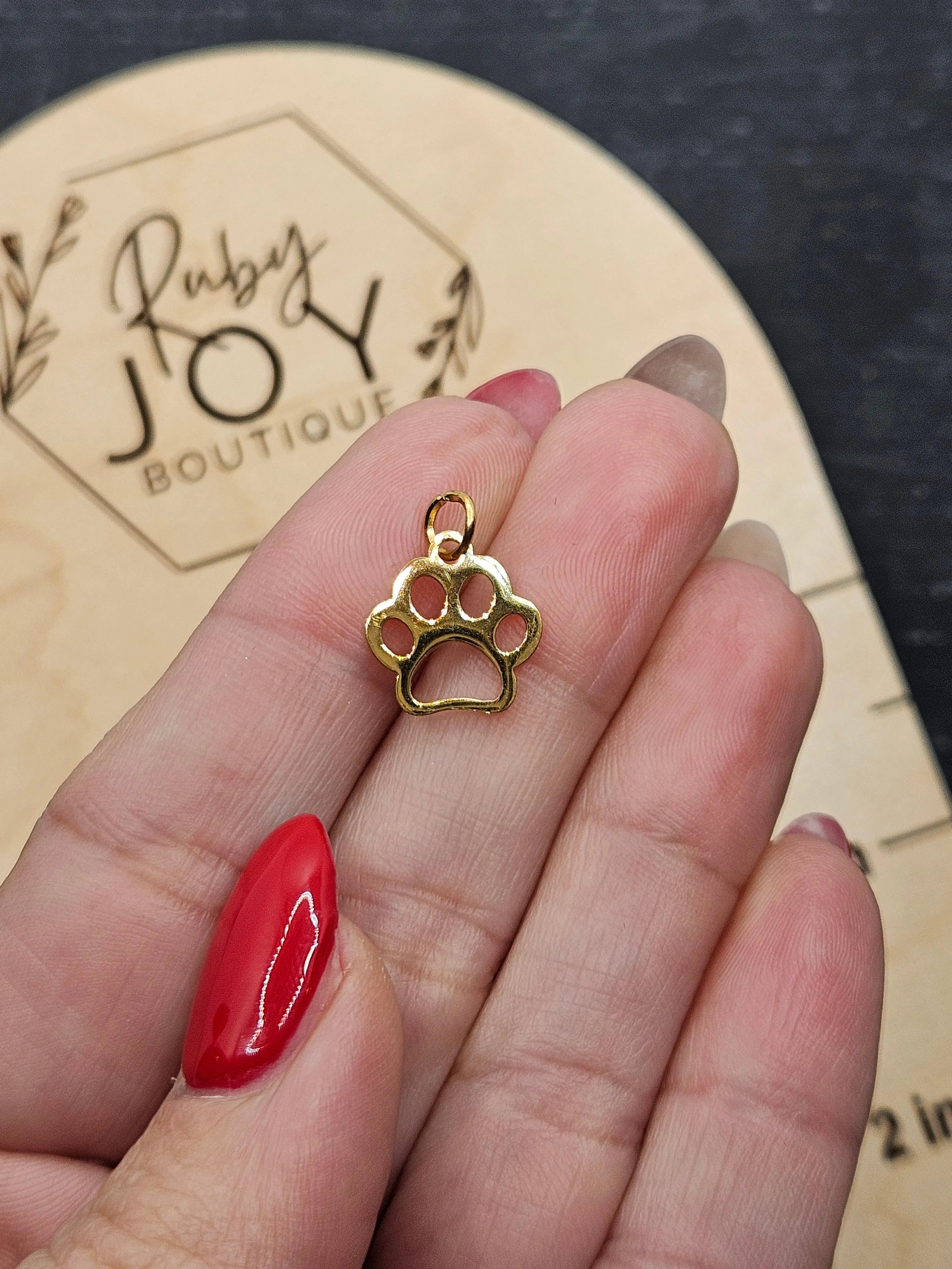 Shop Paw Print Outline Charm- at Ruby Joy Boutique, a Women's Clothing Store in Pickerington, Ohio