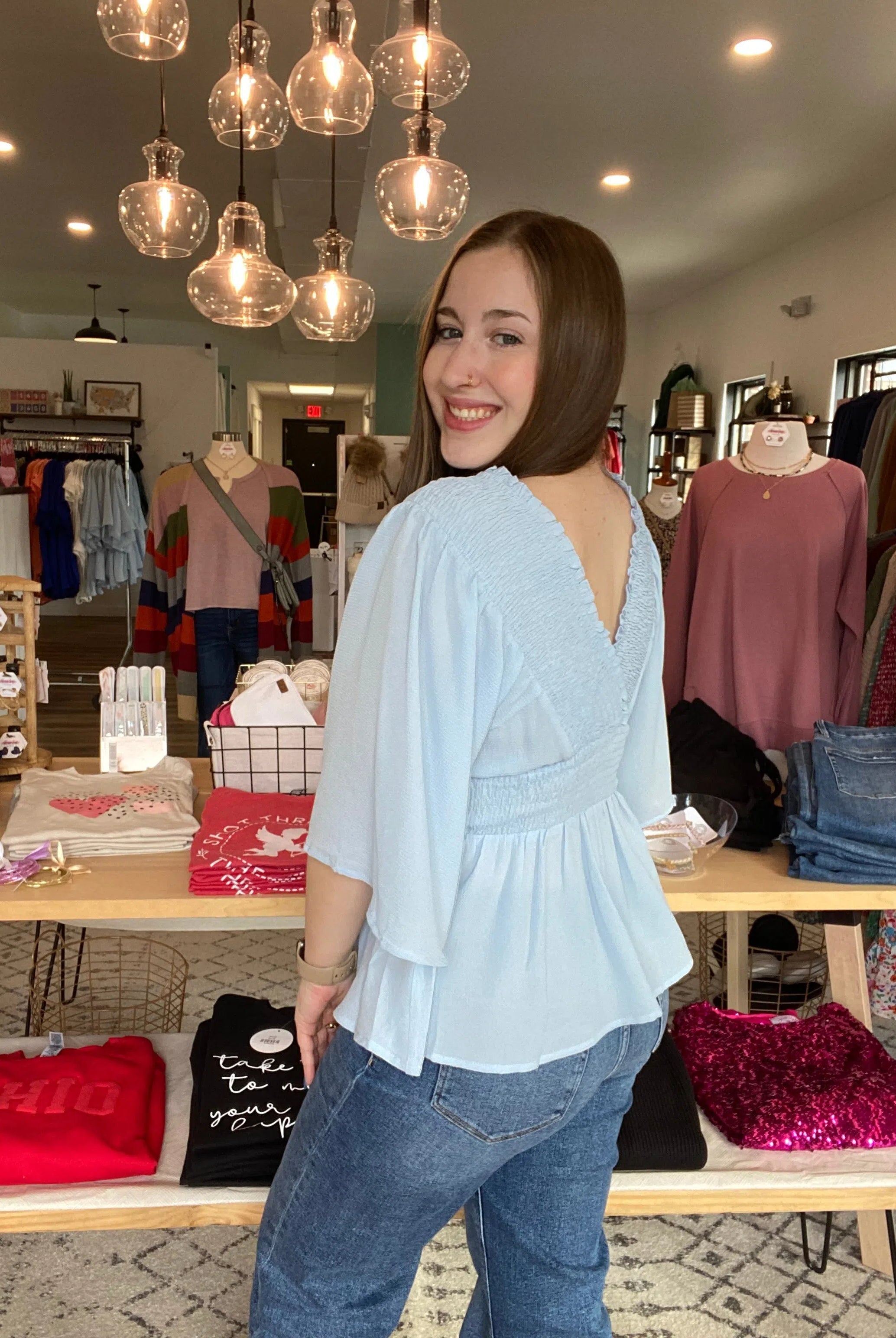 Shop Smocked Surplice Peplum Blouse - Baby Blue-Blouse at Ruby Joy Boutique, a Women's Clothing Store in Pickerington, Ohio