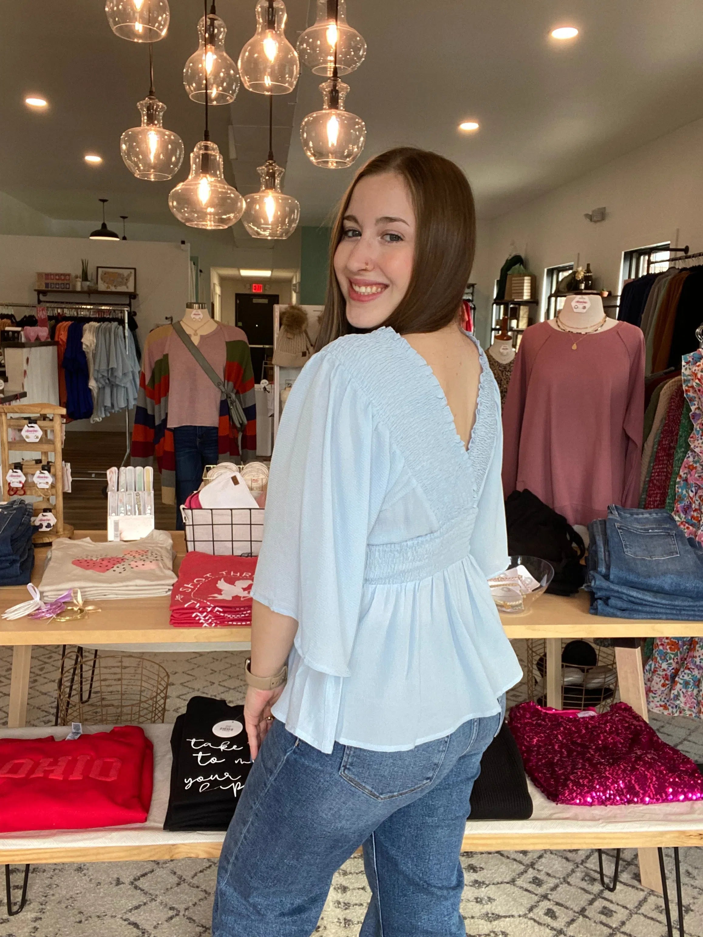 Shop Smocked Surplice Peplum Blouse - Baby Blue-Blouse at Ruby Joy Boutique, a Women's Clothing Store in Pickerington, Ohio