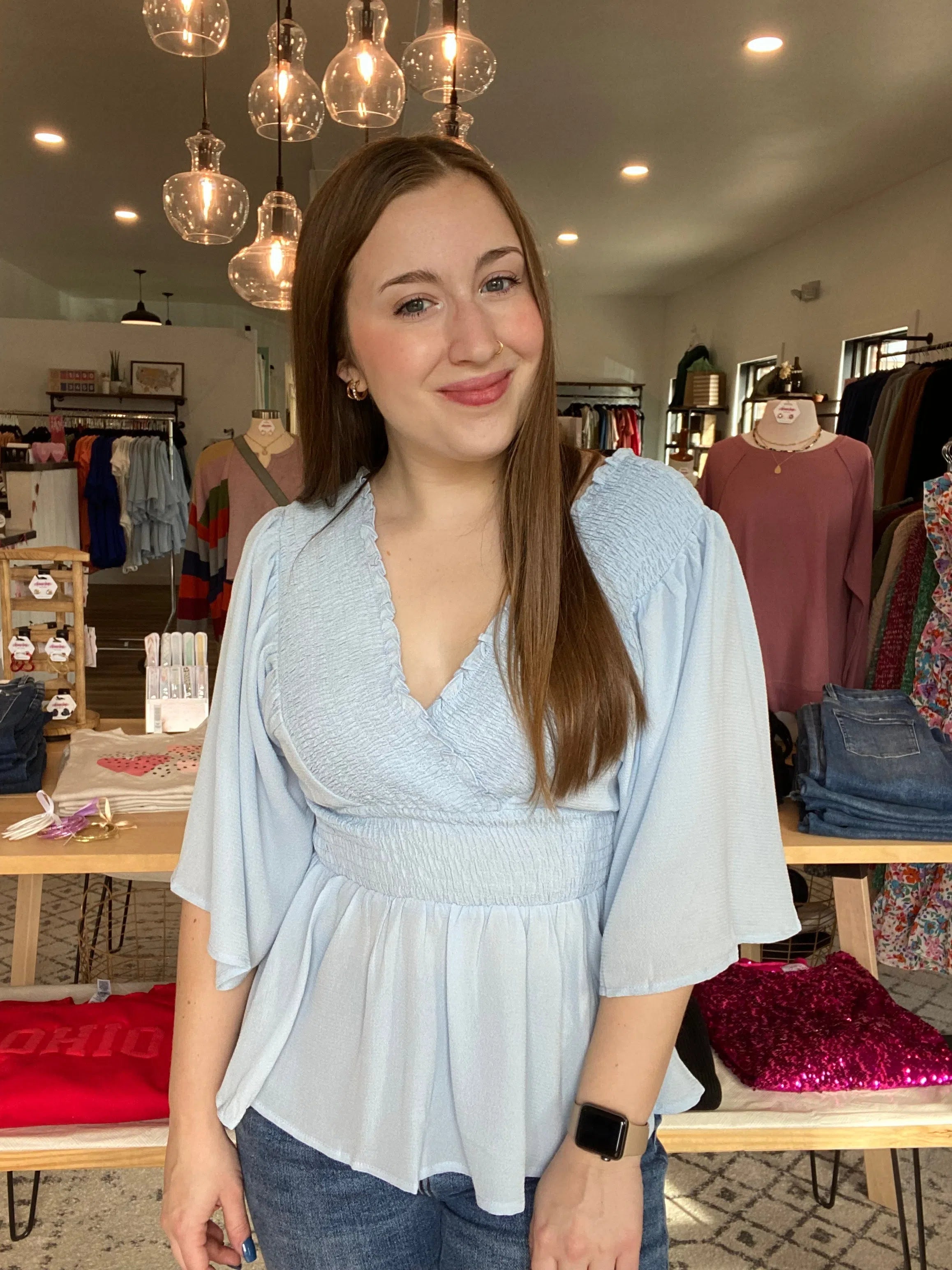 Shop Smocked Surplice Peplum Blouse - Baby Blue-Blouse at Ruby Joy Boutique, a Women's Clothing Store in Pickerington, Ohio