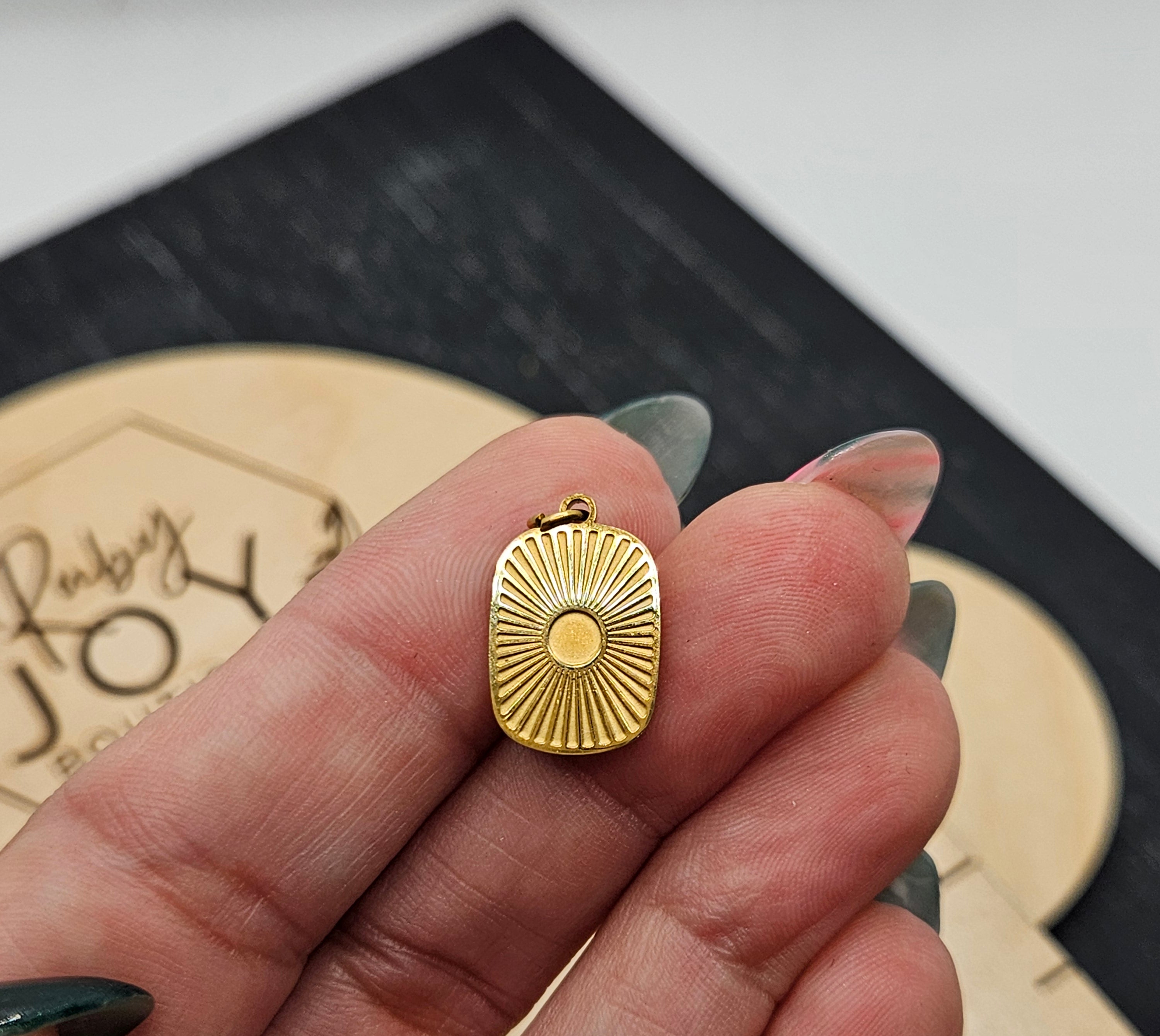 Shop Sunburst Medallion Charm- at Ruby Joy Boutique, a Women's Clothing Store in Pickerington, Ohio
