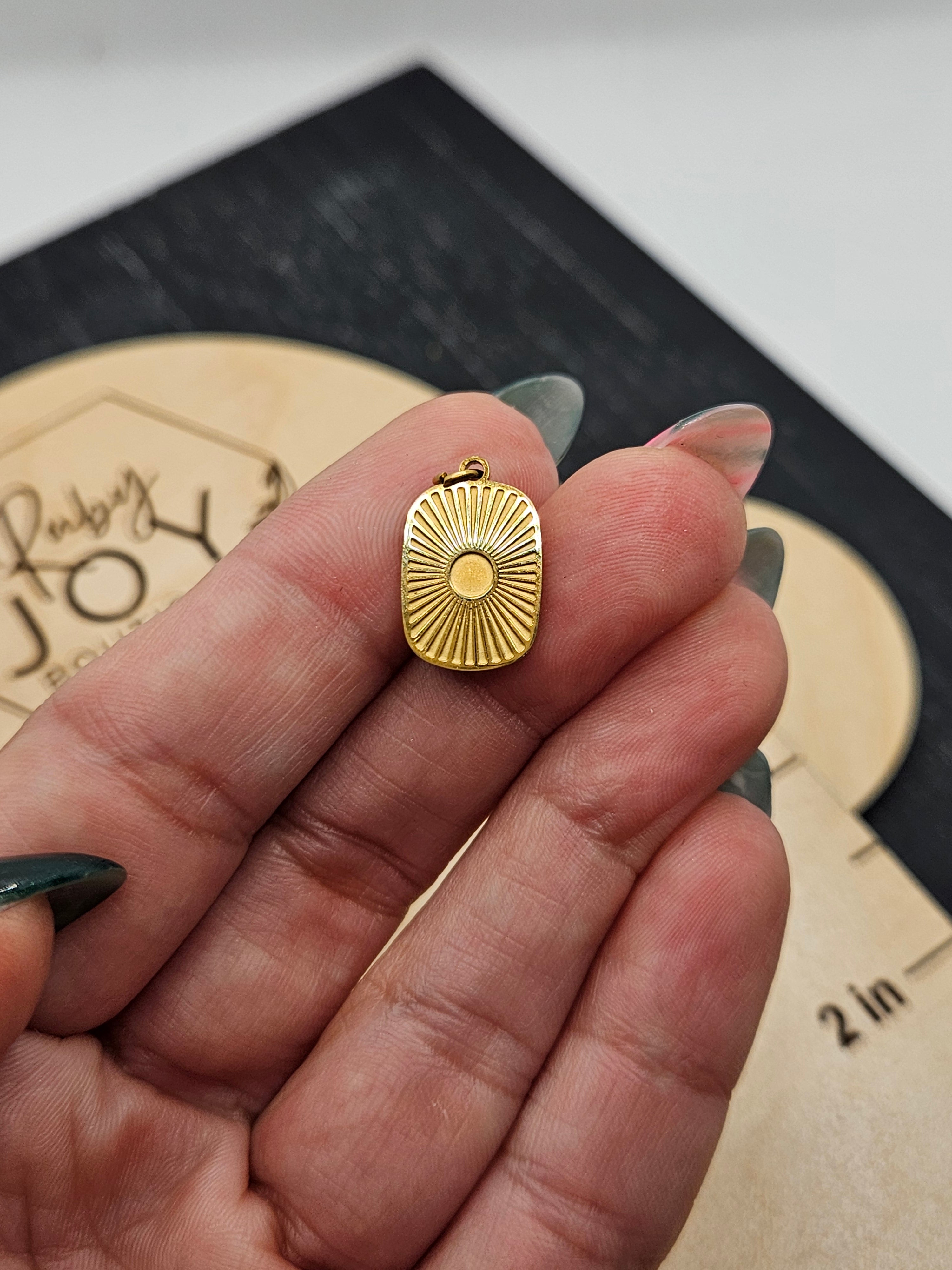 Shop Sunburst Medallion Charm- at Ruby Joy Boutique, a Women's Clothing Store in Pickerington, Ohio