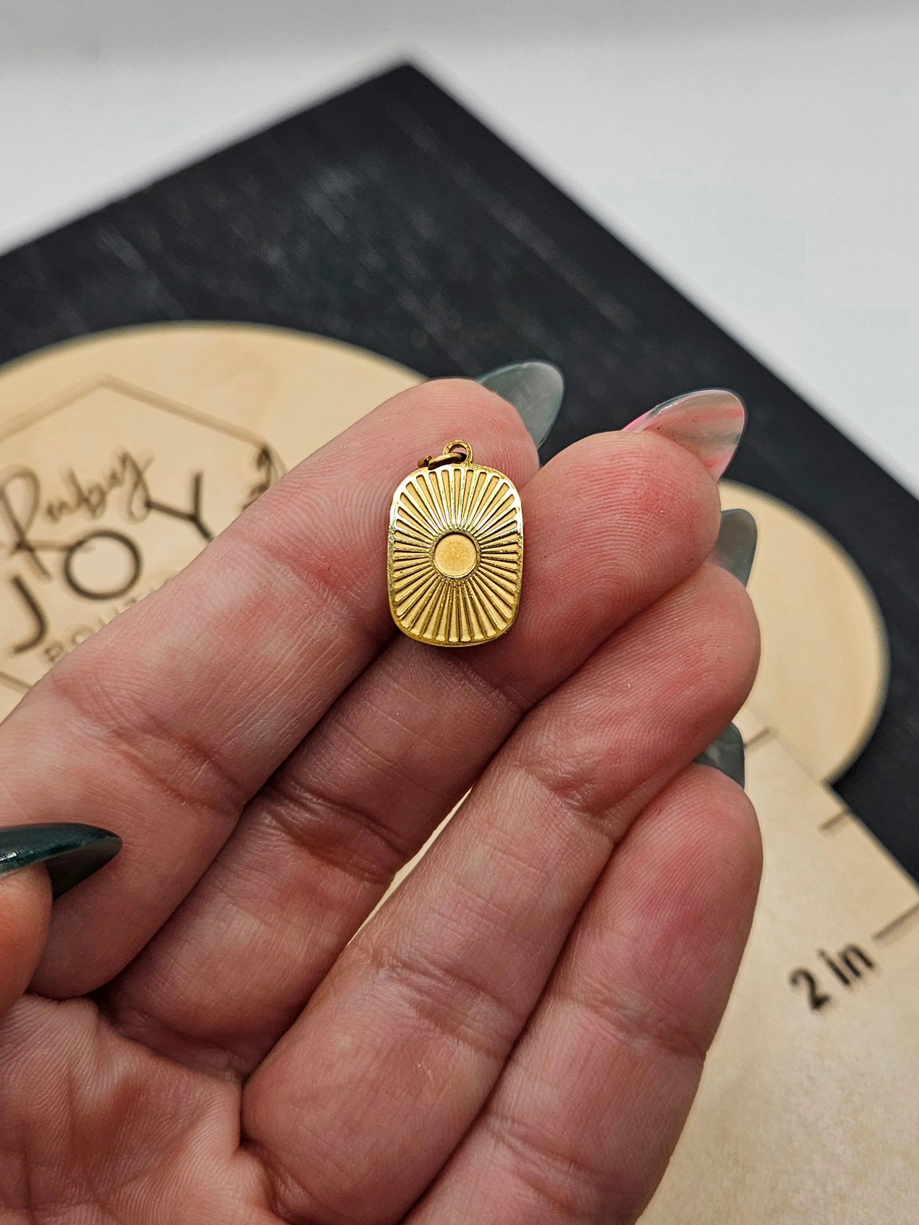 Shop Sunburst Medallion Charm- at Ruby Joy Boutique, a Women's Clothing Store in Pickerington, Ohio