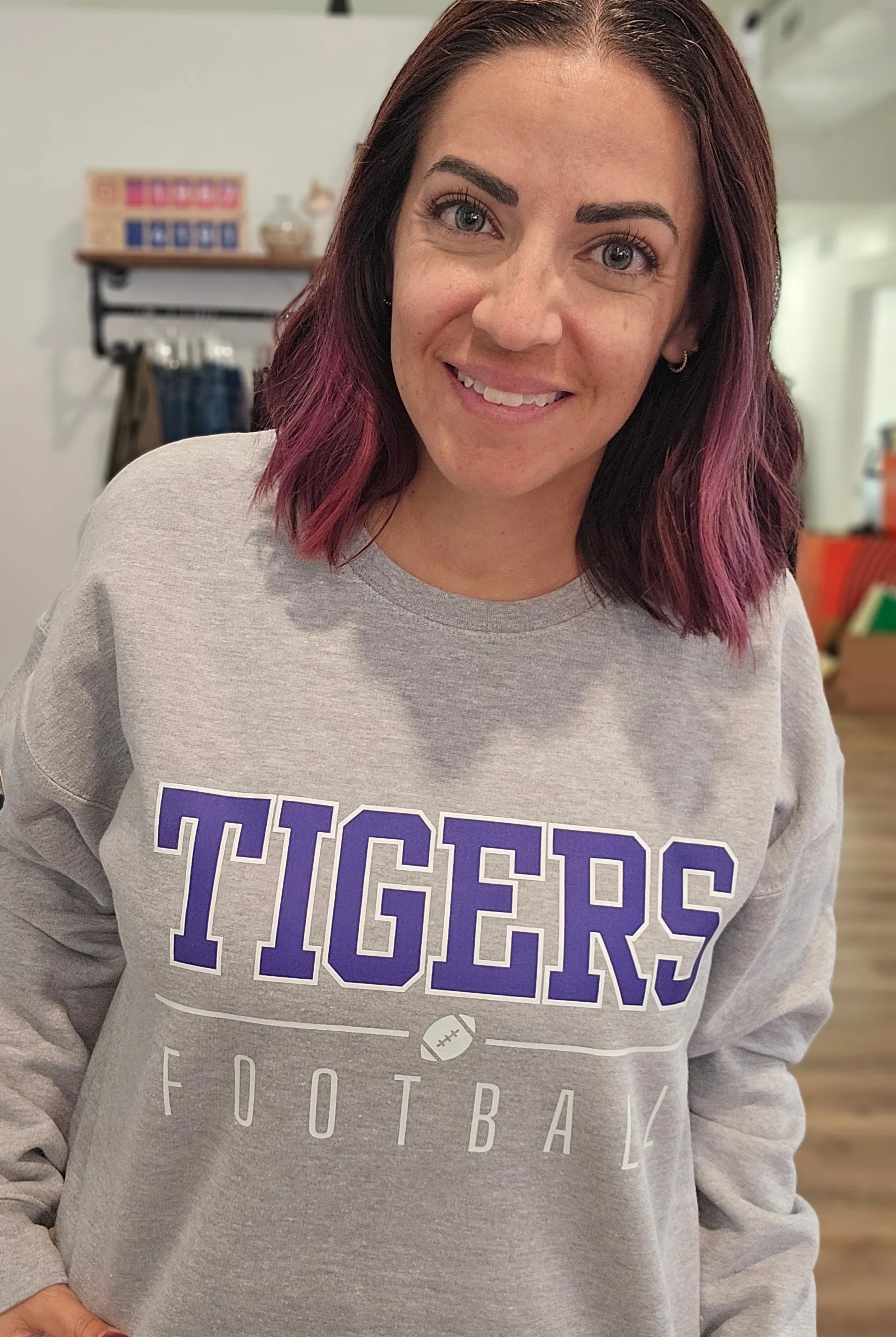 Shop Varsity Football Mascot Sweatshirt- at Ruby Joy Boutique, a Women's Clothing Store in Pickerington, Ohio