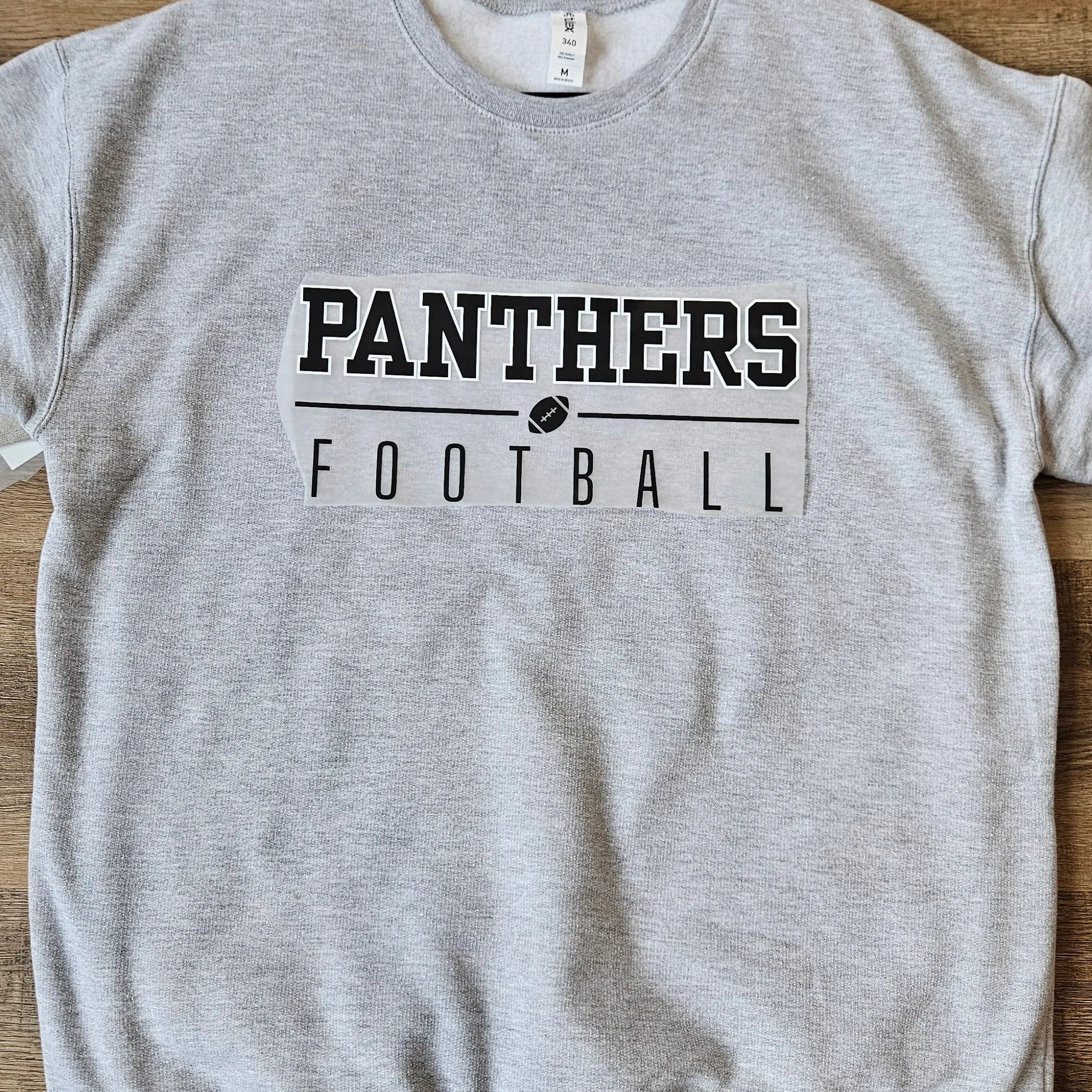 Shop Varsity Football Mascot Sweatshirt-Small at Ruby Joy Boutique, a Women's Clothing Store in Pickerington, Ohio