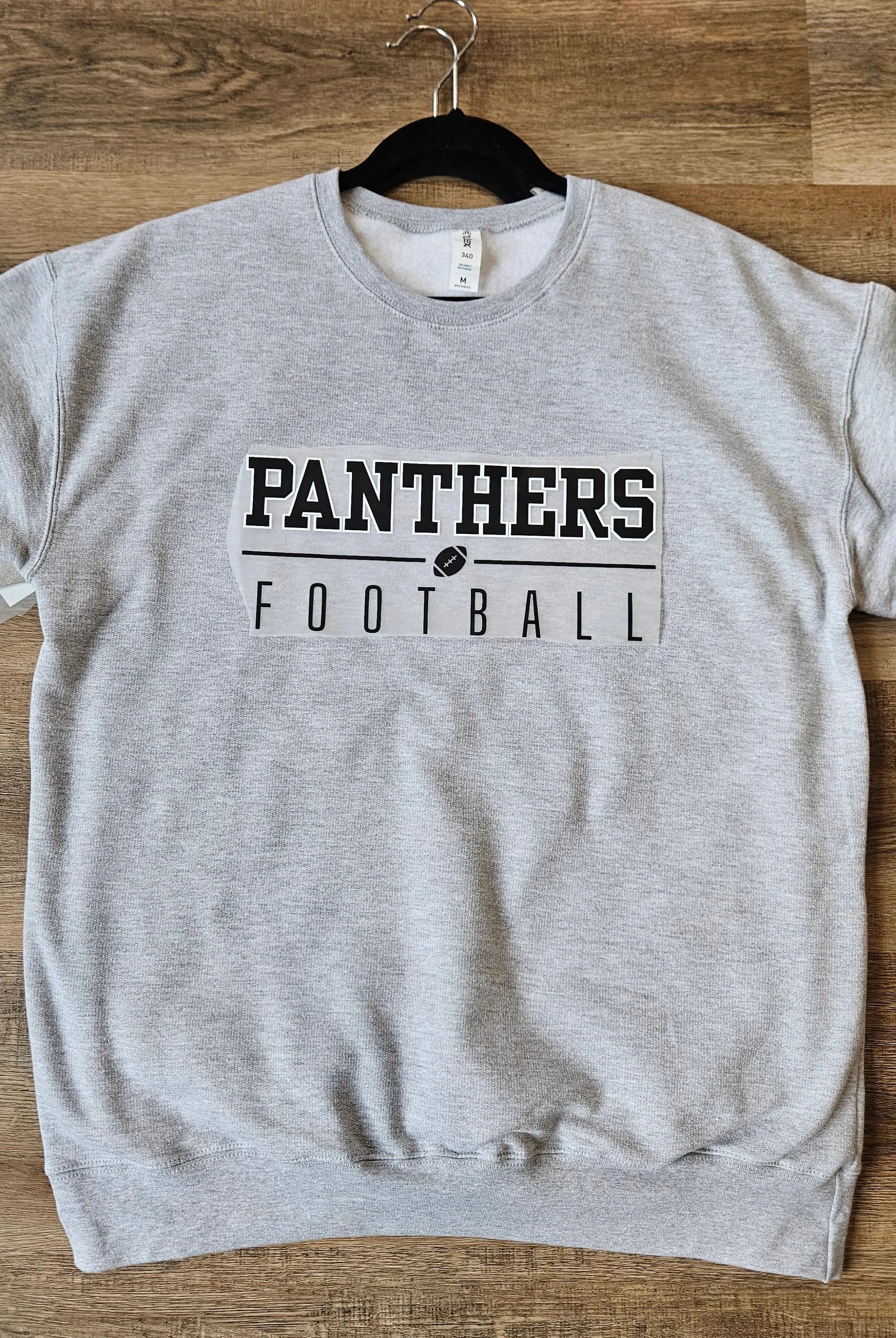 Shop Varsity Football Mascot Sweatshirt-Small at Ruby Joy Boutique, a Women's Clothing Store in Pickerington, Ohio