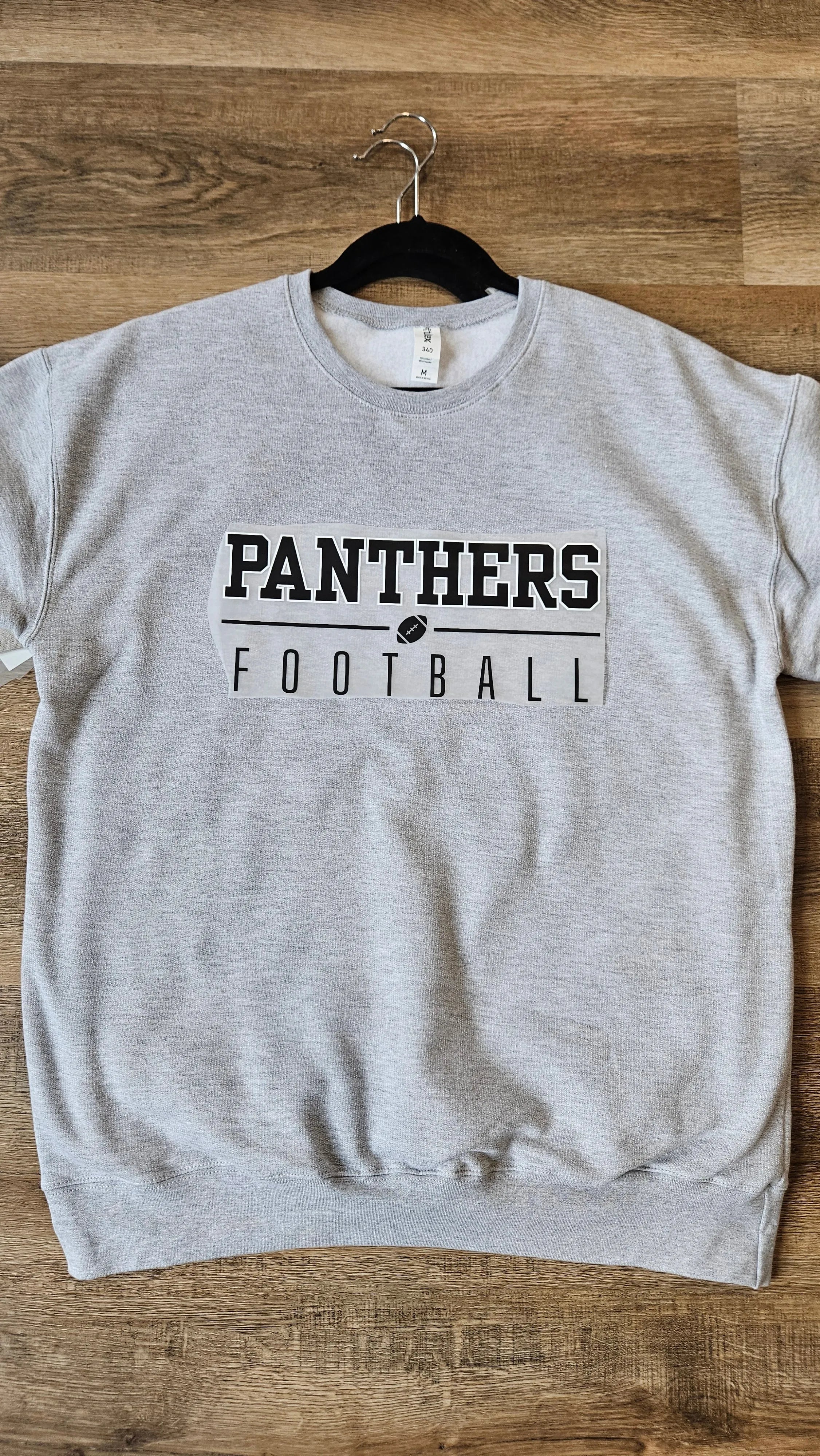 Shop Varsity Football Mascot Sweatshirt-Small at Ruby Joy Boutique, a Women's Clothing Store in Pickerington, Ohio