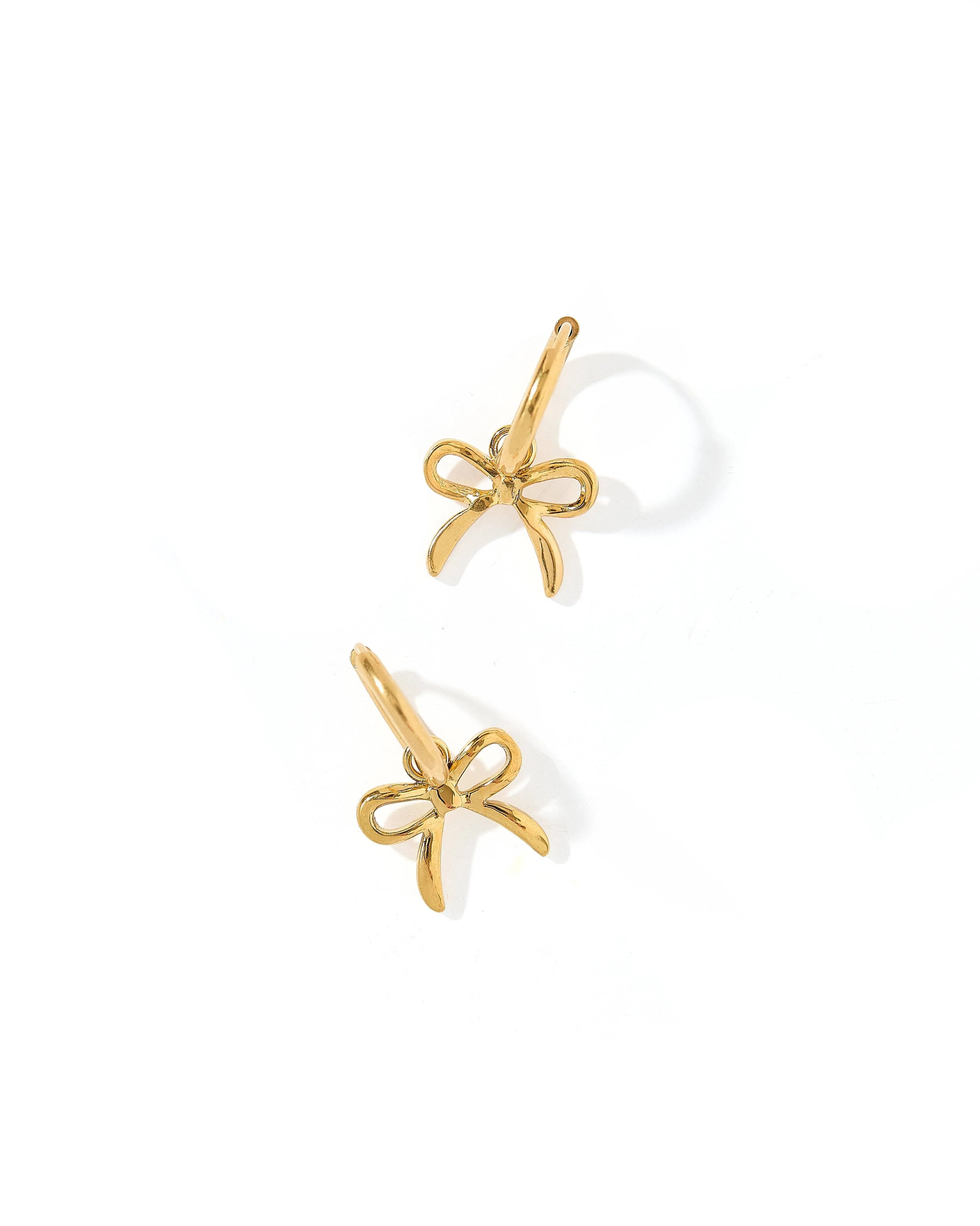 Shop Sadie Bow Huggie Charm Earrings - Gold- at Ruby Joy Boutique, a Women's Clothing Store in Pickerington, Ohio