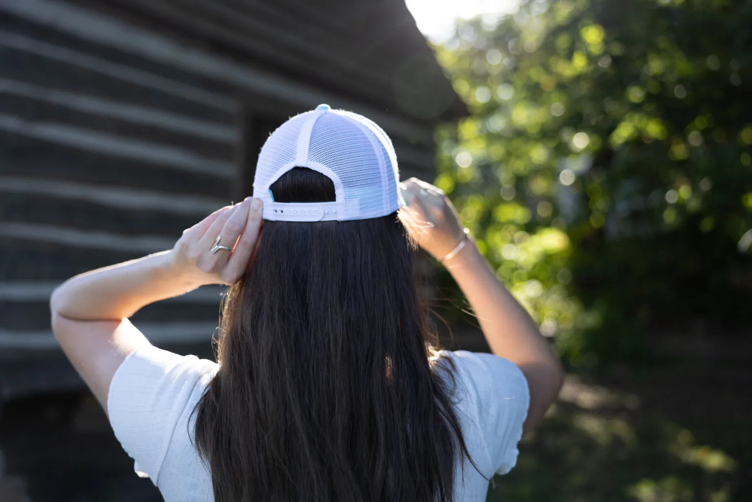 Shop 256 Lacrosse Graphic Women's Trucker Hat with Evolve™ Concealed Ponytail Opening- at Ruby Joy Boutique, a Women's Clothing Store in Pickerington, Ohio