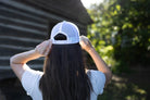 Shop 256 Lacrosse Graphic Women's Trucker Hat with Evolve™ Concealed Ponytail Opening- at Ruby Joy Boutique, a Women's Clothing Store in Pickerington, Ohio
