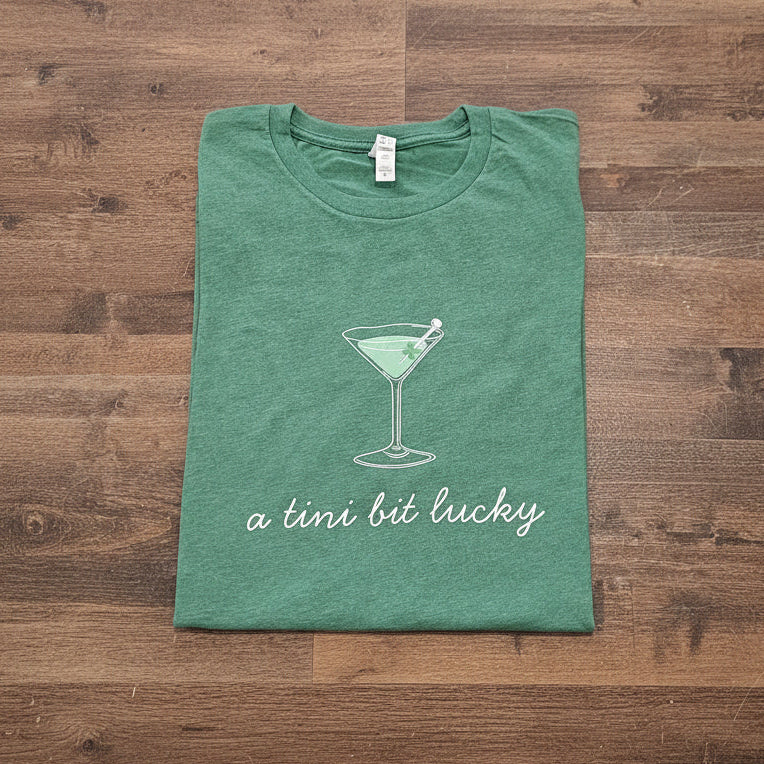 Shop A Tini Bit Lucky | St. Patrick's Day Graphic Top- at Ruby Joy Boutique, a Women's Clothing Store in Pickerington, Ohio