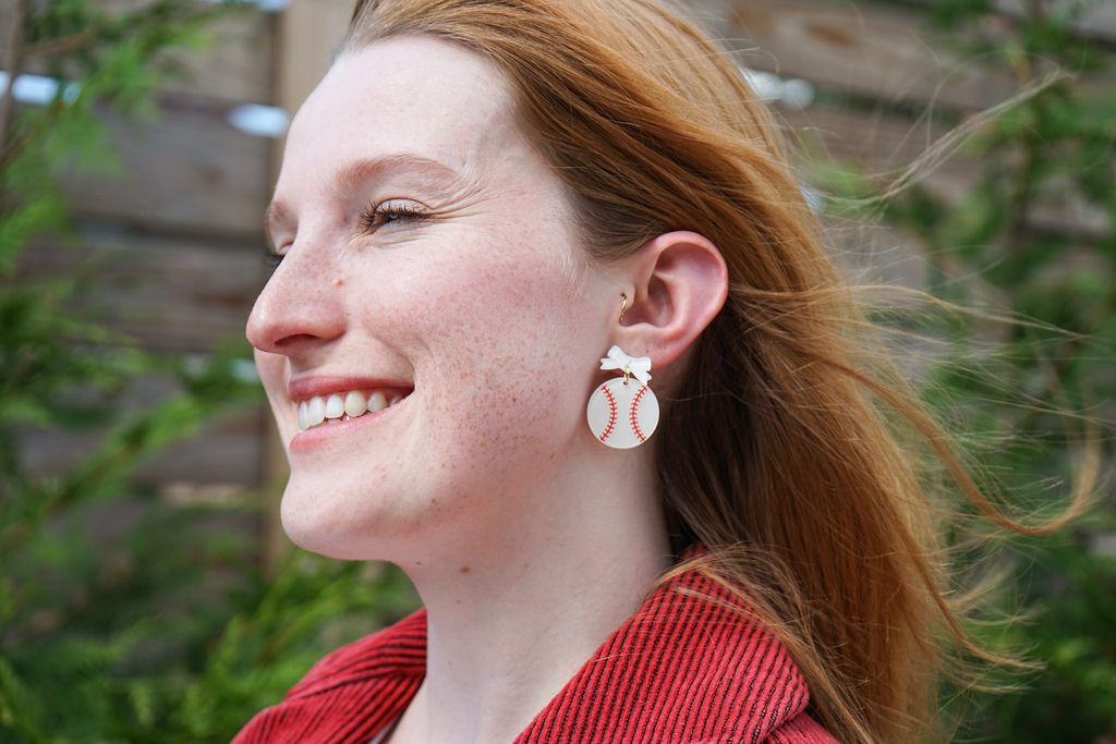Shop Bow Baseball Earrings- at Ruby Joy Boutique, a Women's Clothing Store in Pickerington, Ohio