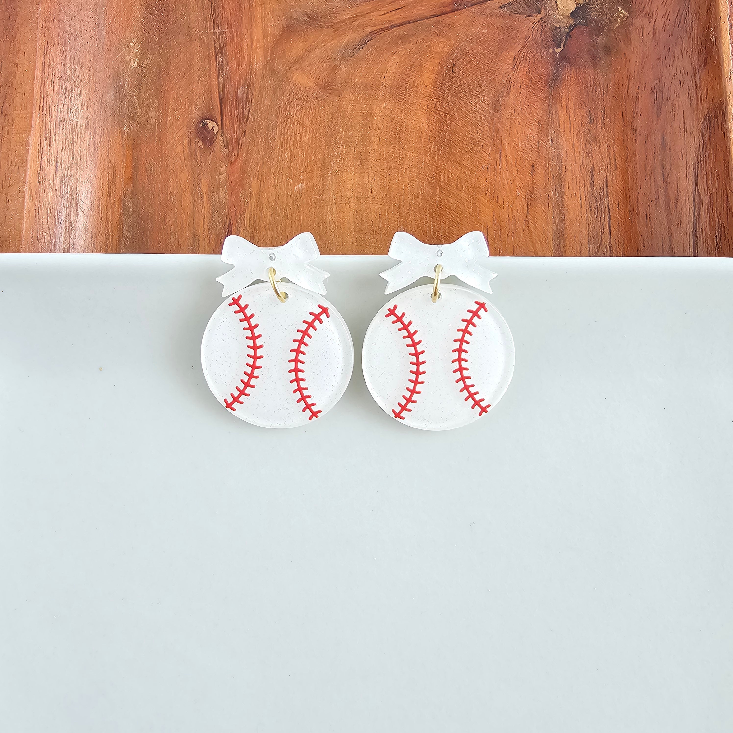 Shop Bow Baseball Earrings- at Ruby Joy Boutique, a Women's Clothing Store in Pickerington, Ohio