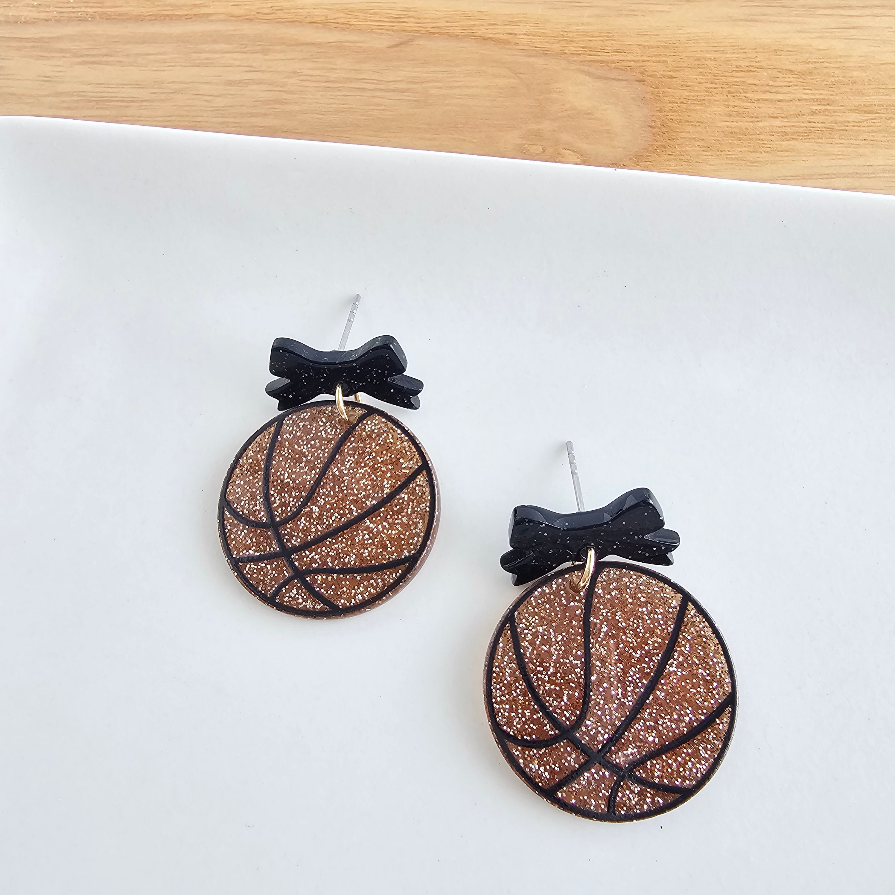Shop Bow Basketball Earrings- at Ruby Joy Boutique, a Women's Clothing Store in Pickerington, Ohio