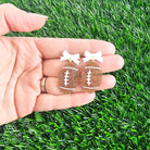 Shop Bow Football Earrings- at Ruby Joy Boutique, a Women's Clothing Store in Pickerington, Ohio