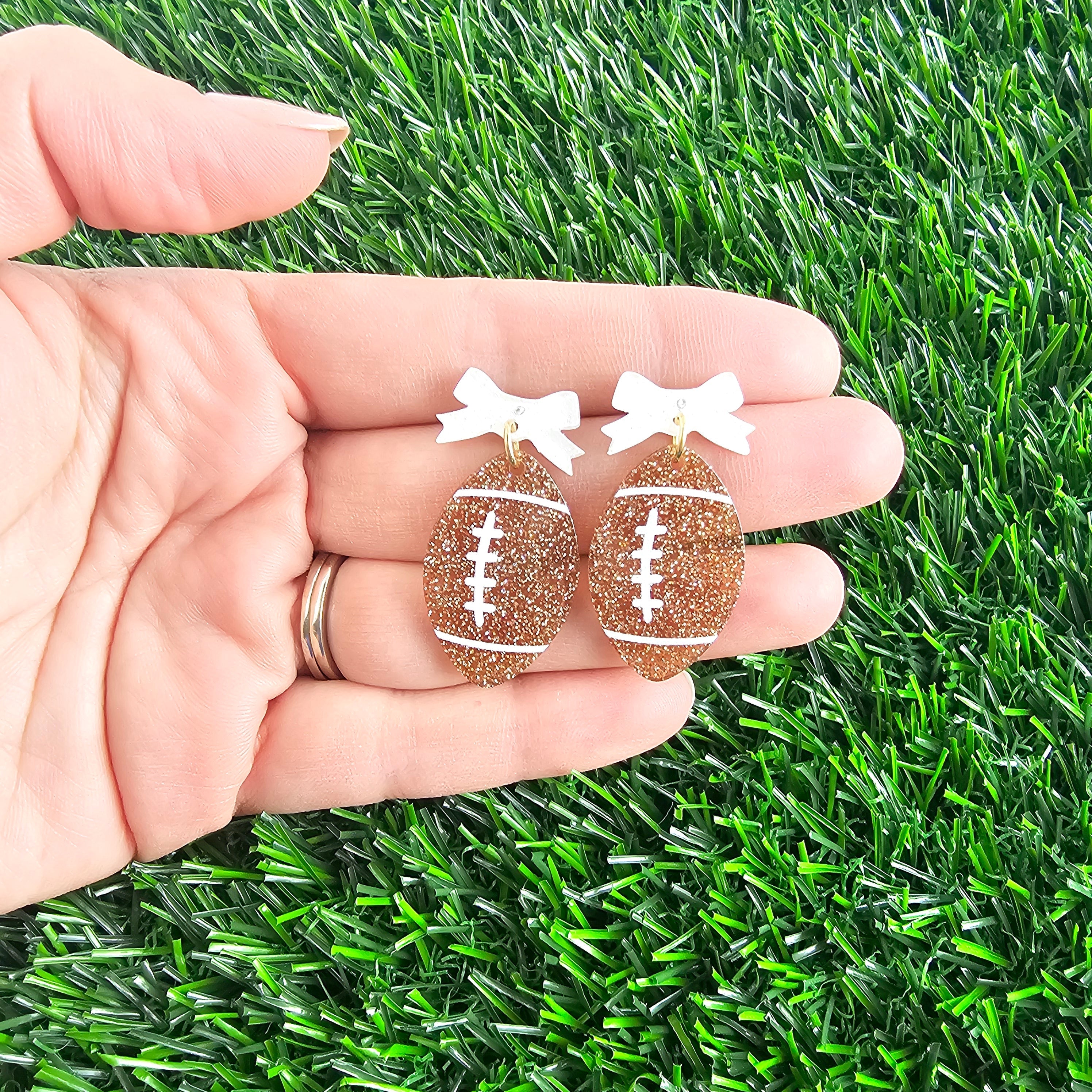 Shop Bow Football Earrings- at Ruby Joy Boutique, a Women's Clothing Store in Pickerington, Ohio