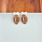 Shop Bow Football Earrings- at Ruby Joy Boutique, a Women's Clothing Store in Pickerington, Ohio