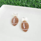 Shop Bow Football Earrings- at Ruby Joy Boutique, a Women's Clothing Store in Pickerington, Ohio