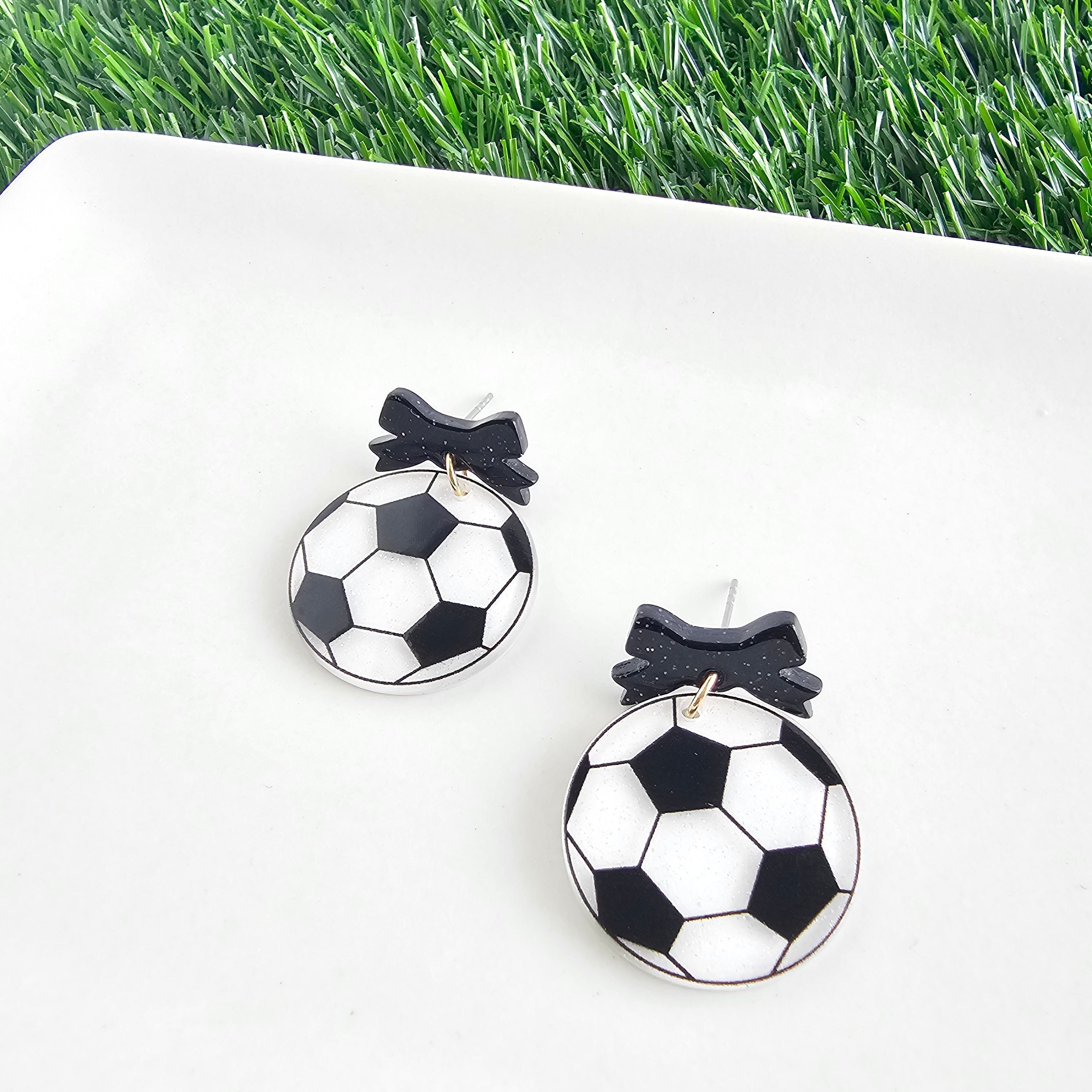 Shop Bow Soccer Ball Earrings- at Ruby Joy Boutique, a Women's Clothing Store in Pickerington, Ohio