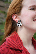 Shop Bow Soccer Ball Earrings- at Ruby Joy Boutique, a Women's Clothing Store in Pickerington, Ohio