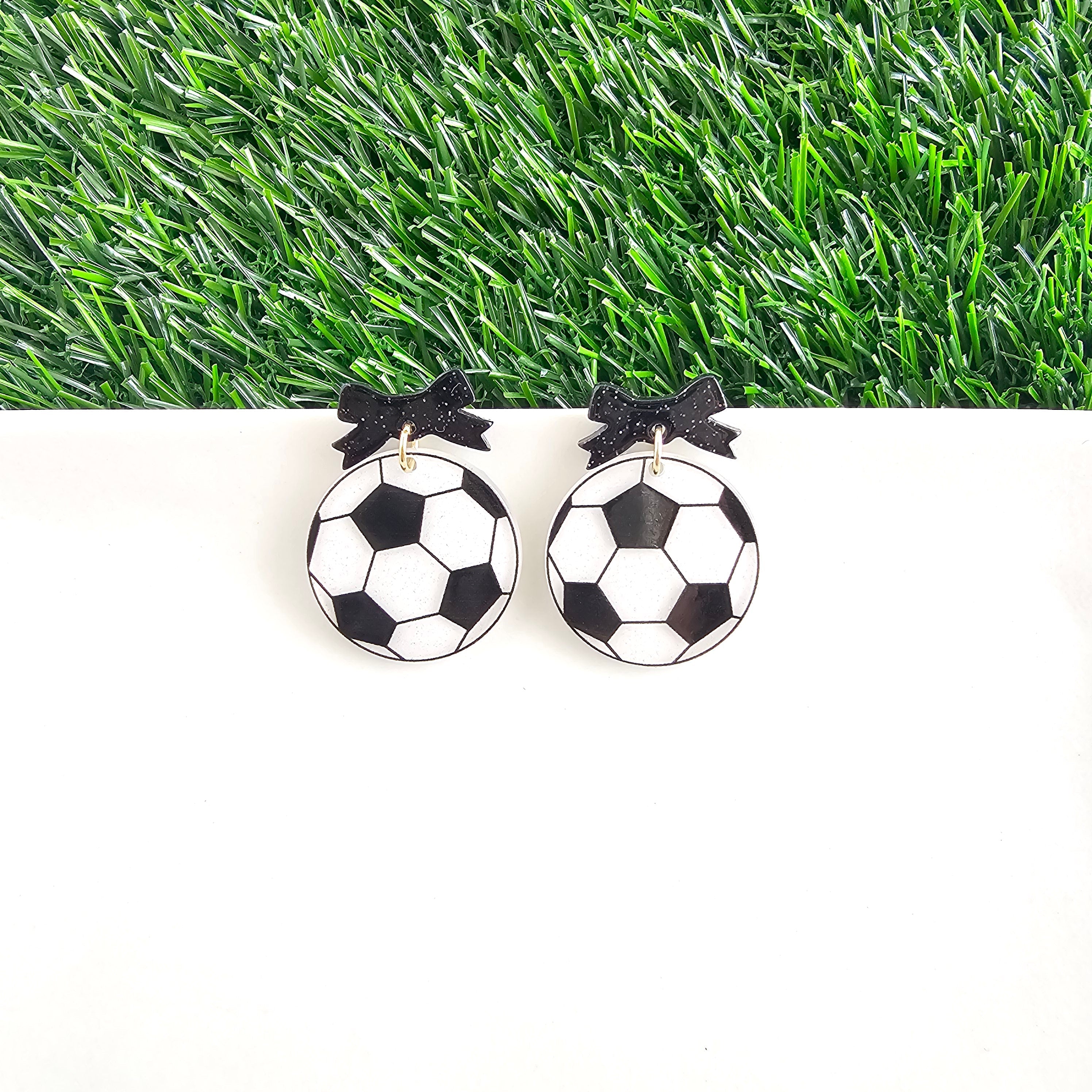 Shop Bow Soccer Ball Earrings- at Ruby Joy Boutique, a Women's Clothing Store in Pickerington, Ohio