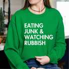 Shop Eating Junk & Watching Rubbish Graphic Top | Home Alone Christmas- at Ruby Joy Boutique, a Women's Clothing Store in Pickerington, Ohio