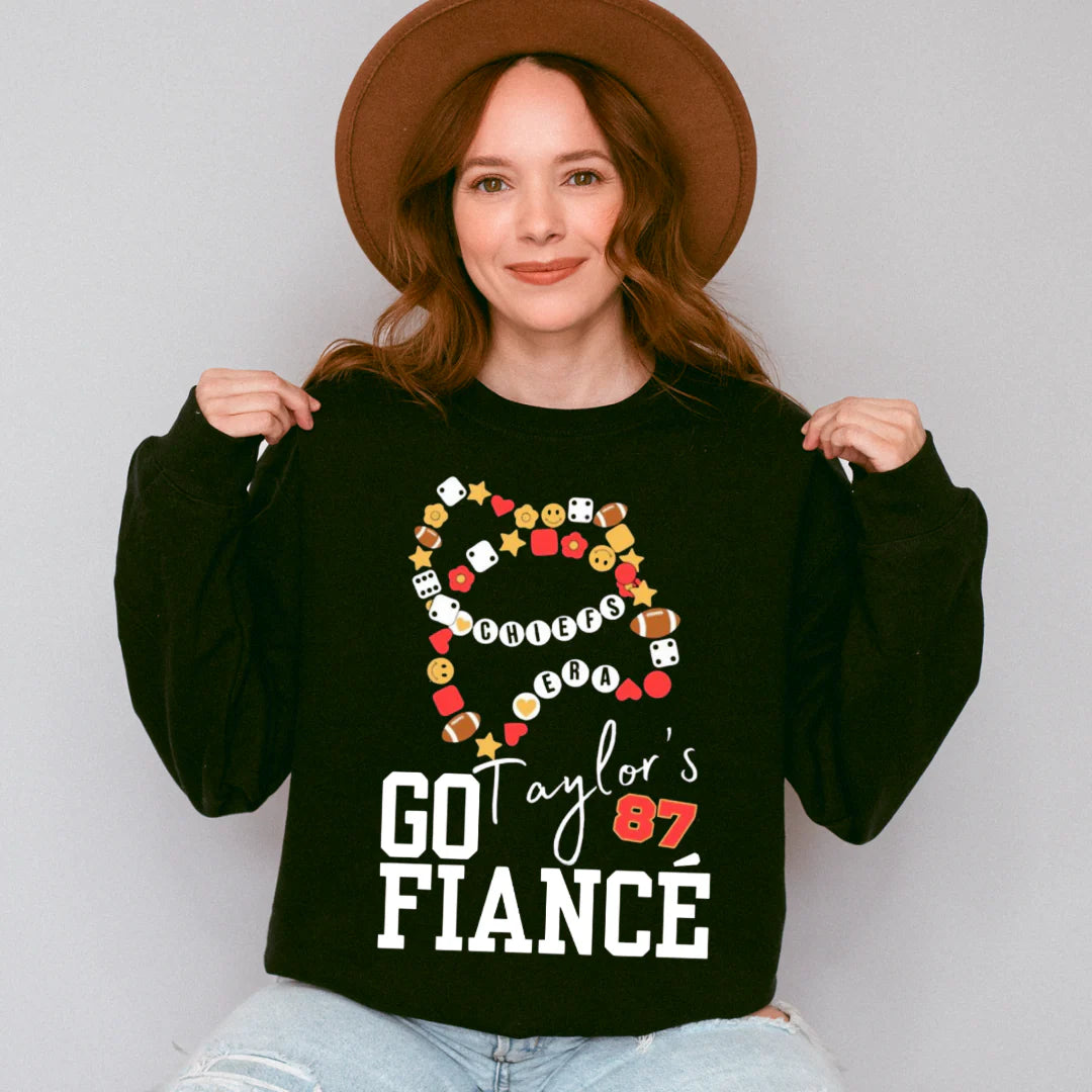 Shop Go Taylor’s Fiancé Bracelet Graphic-Black Comfort Colors Tee at Ruby Joy Boutique, a Women's Clothing Store in Pickerington, Ohio