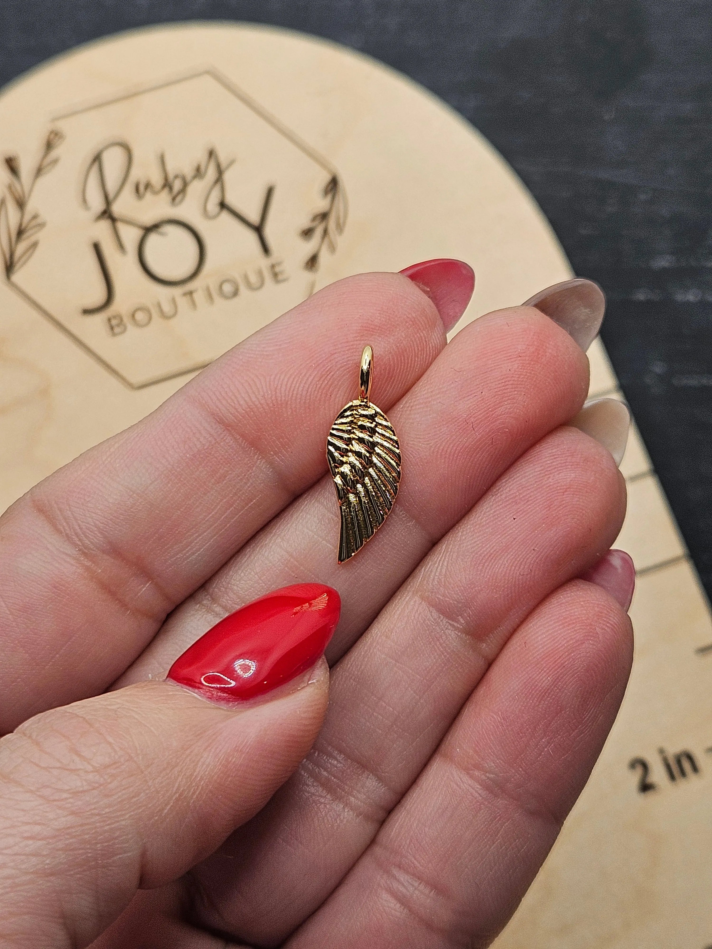 Shop Gold Wing Charm- at Ruby Joy Boutique, a Women's Clothing Store in Pickerington, Ohio