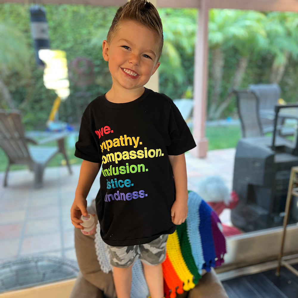 Shop 'Kindness Is' Pride Kids Tee | Kind Cotton- at Ruby Joy Boutique, a Women's Clothing Store in Pickerington, Ohio