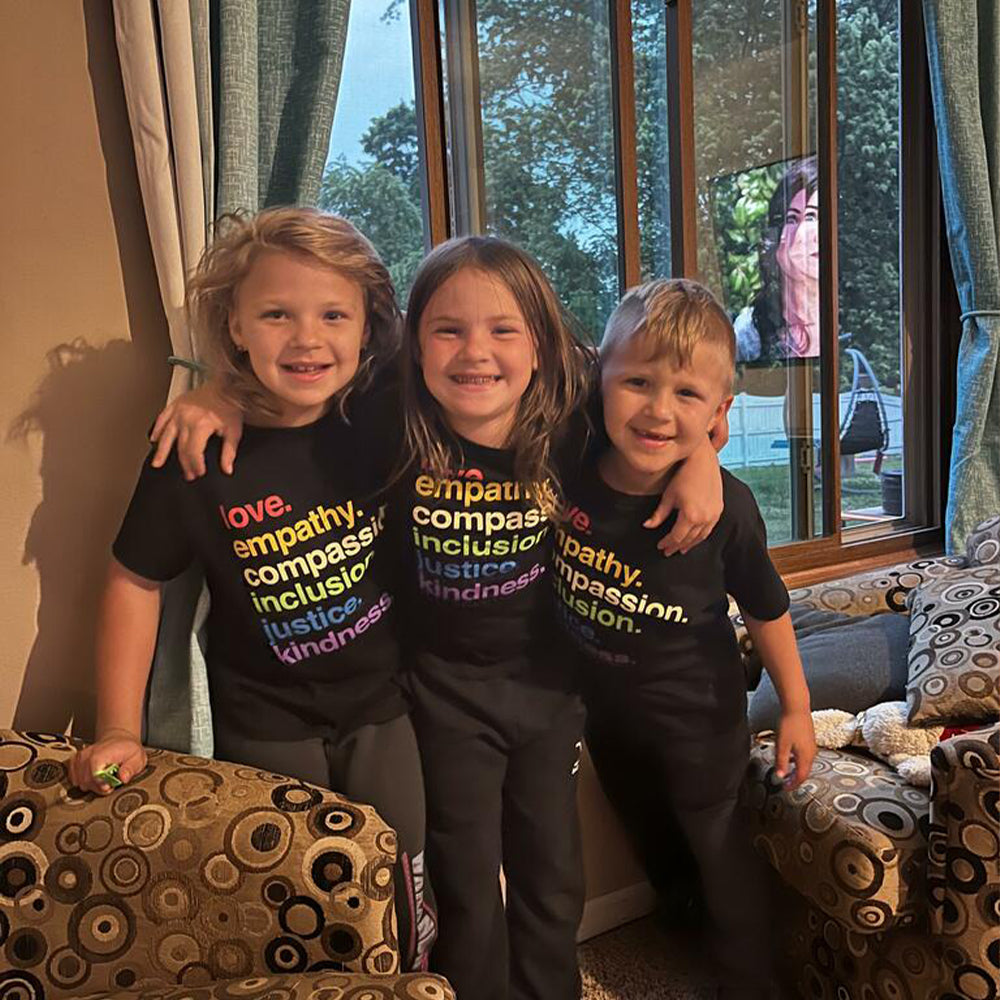 Shop 'Kindness Is' Pride Kids Tee | Kind Cotton- at Ruby Joy Boutique, a Women's Clothing Store in Pickerington, Ohio