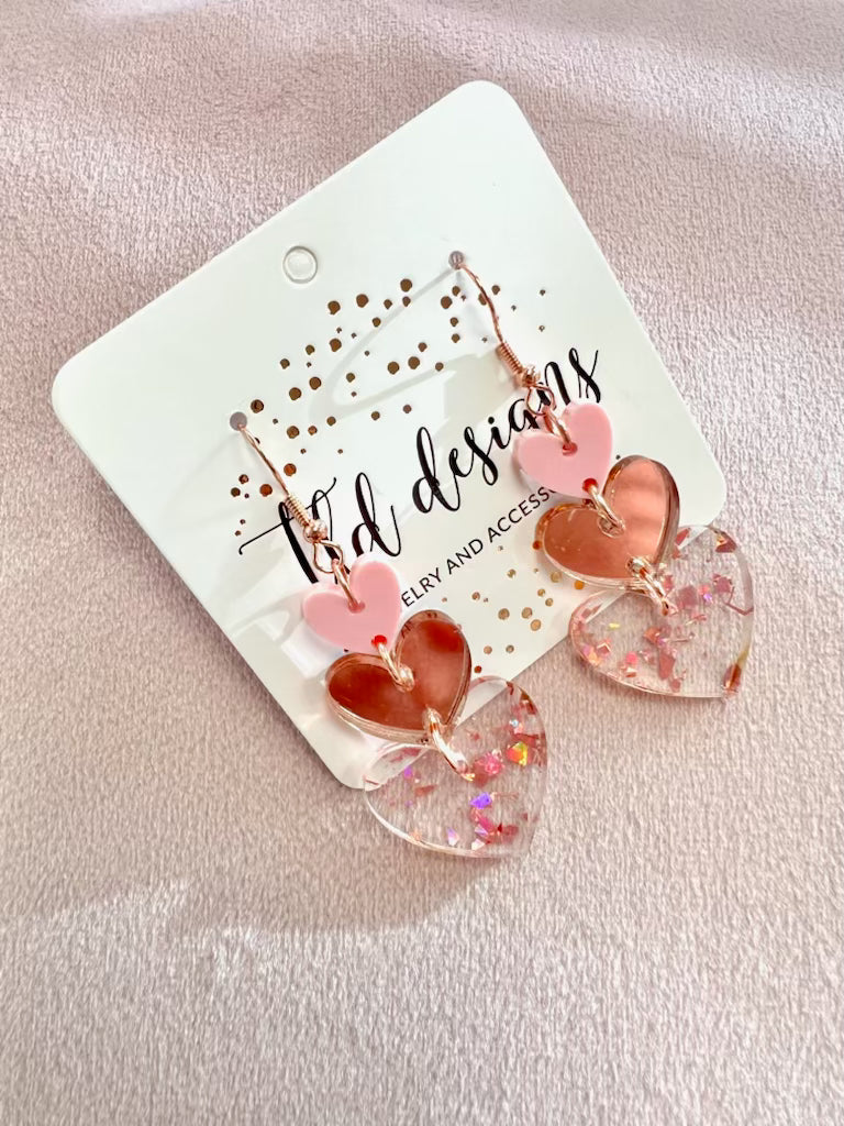 Shop Rosy Triple Heart Dangle Earrings- at Ruby Joy Boutique, a Women's Clothing Store in Pickerington, Ohio