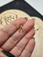 Shop Wishbone Charm- at Ruby Joy Boutique, a Women's Clothing Store in Pickerington, Ohio